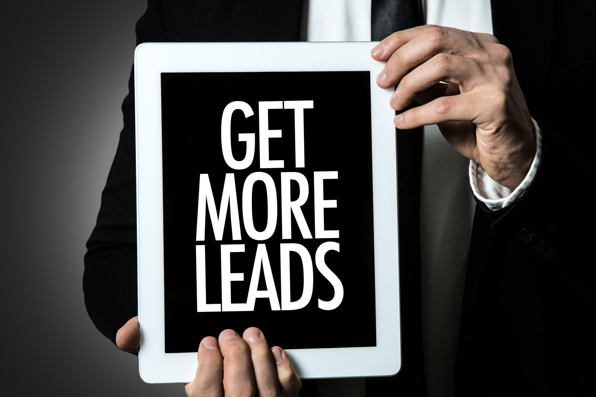 businessman holding tablet saying get more leads