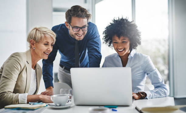 marketers happily looking at laptop