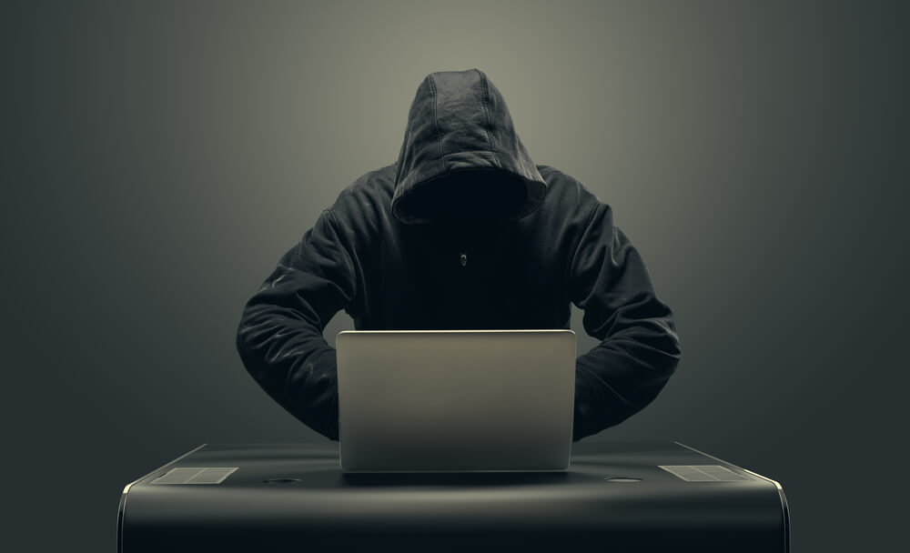 scammer behind a computer trying to scam an SEO West Palm Beach company