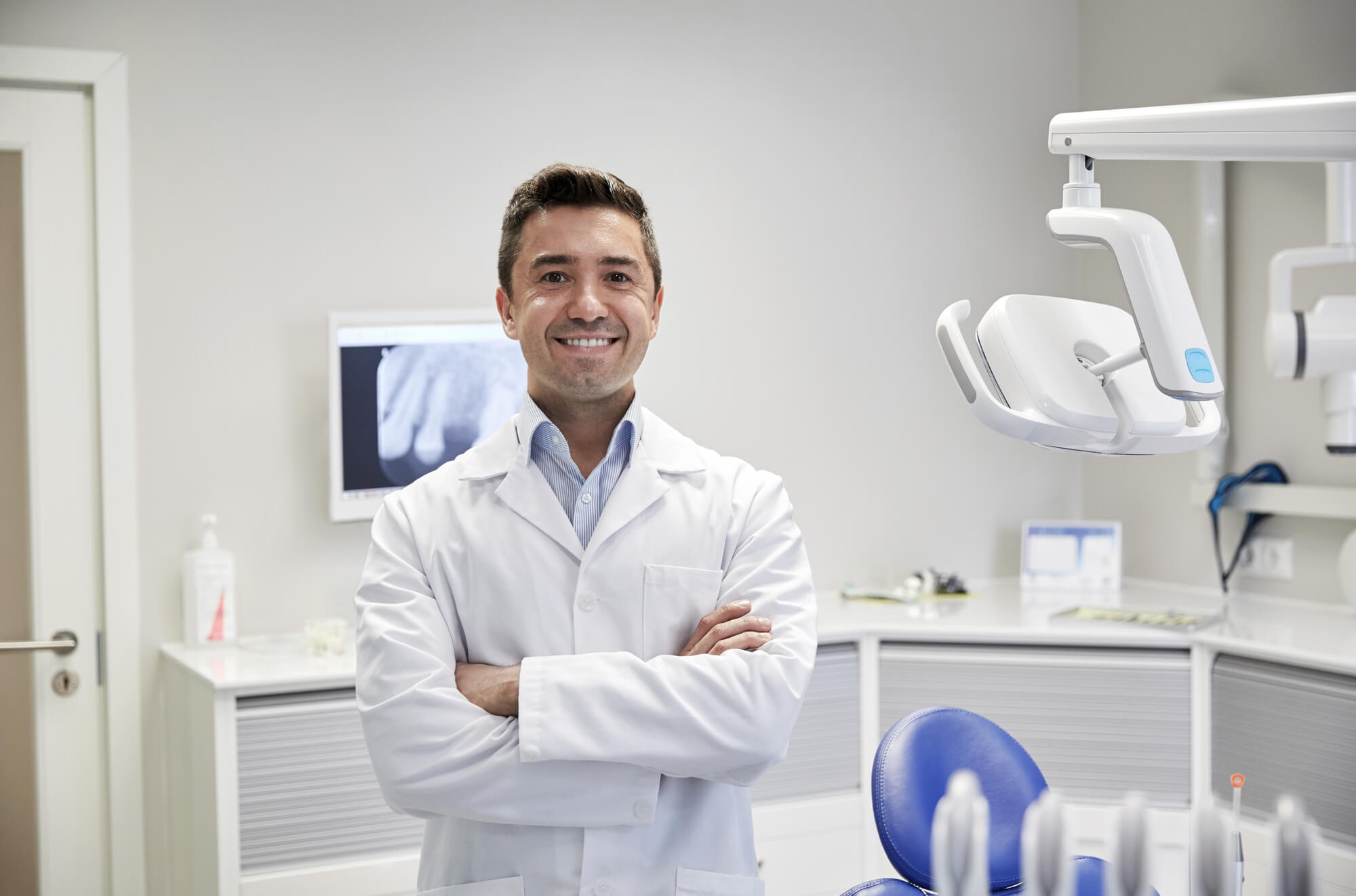 male dentist smiling at the camera