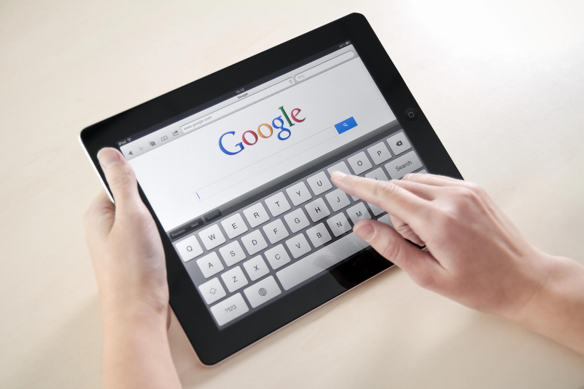 person searching google using tablet