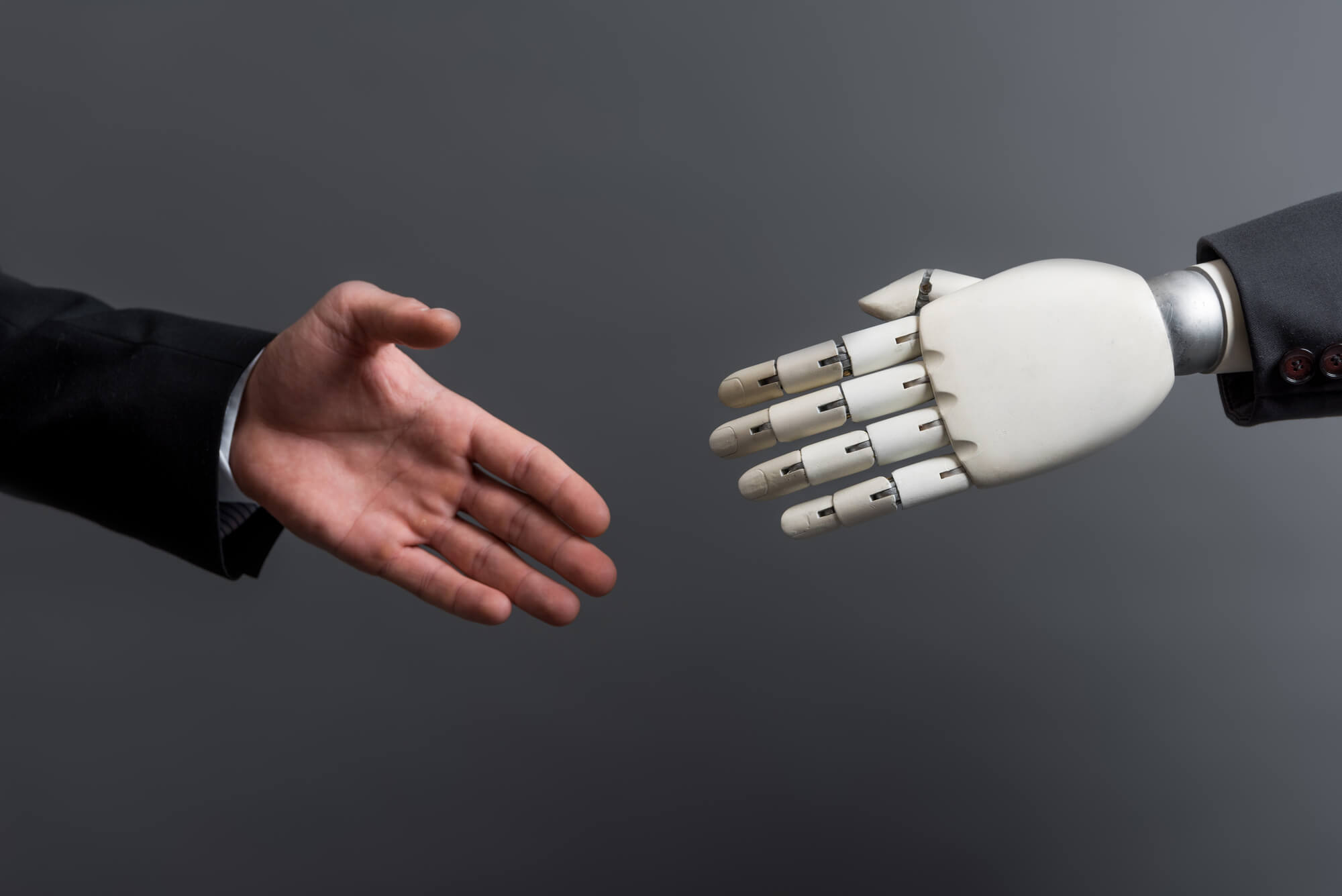 Professional man and bot extending their hands for a handshake