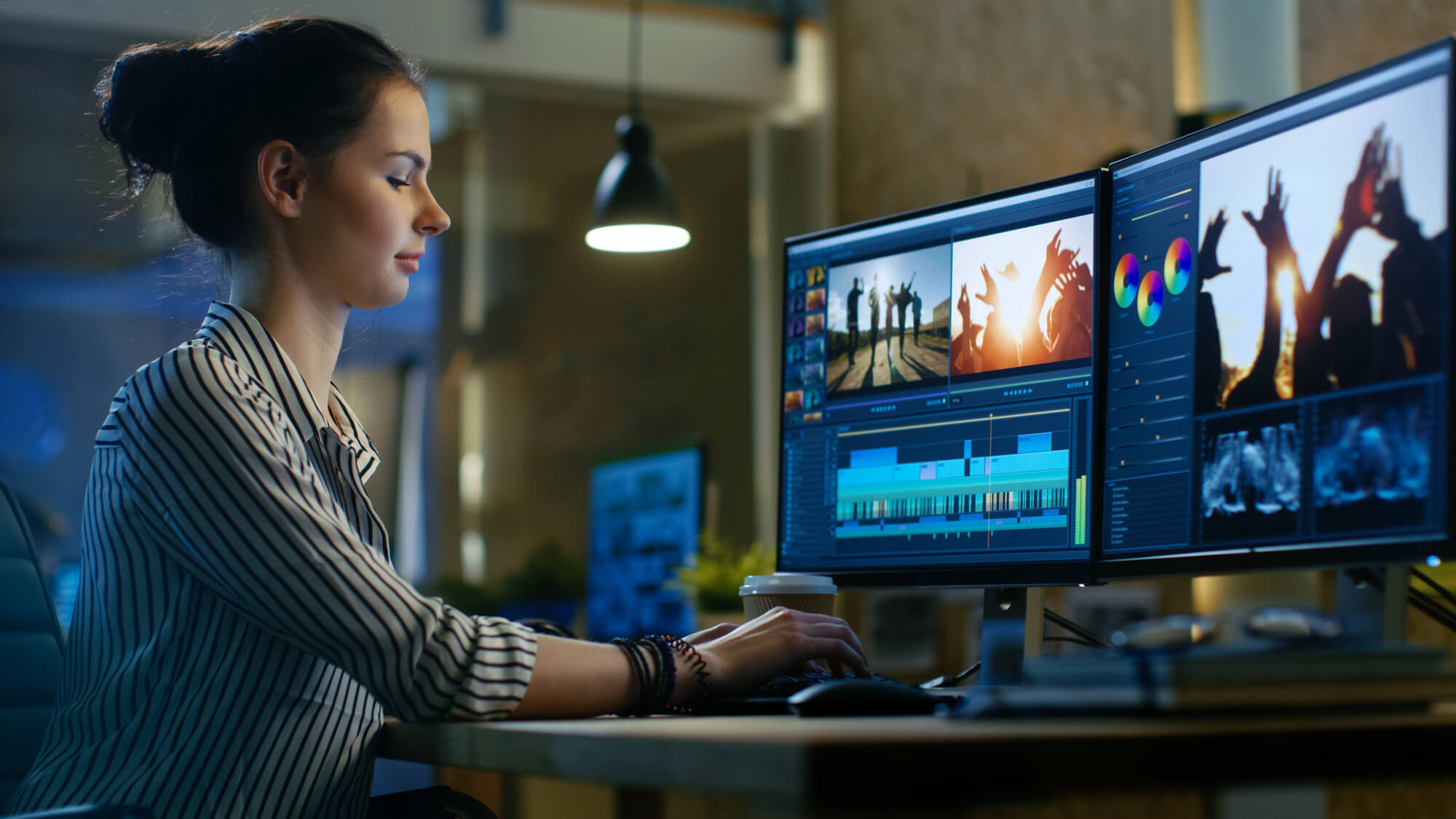 Female videographer editing a video on computer
