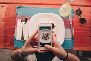 person taking photo of food florida seo