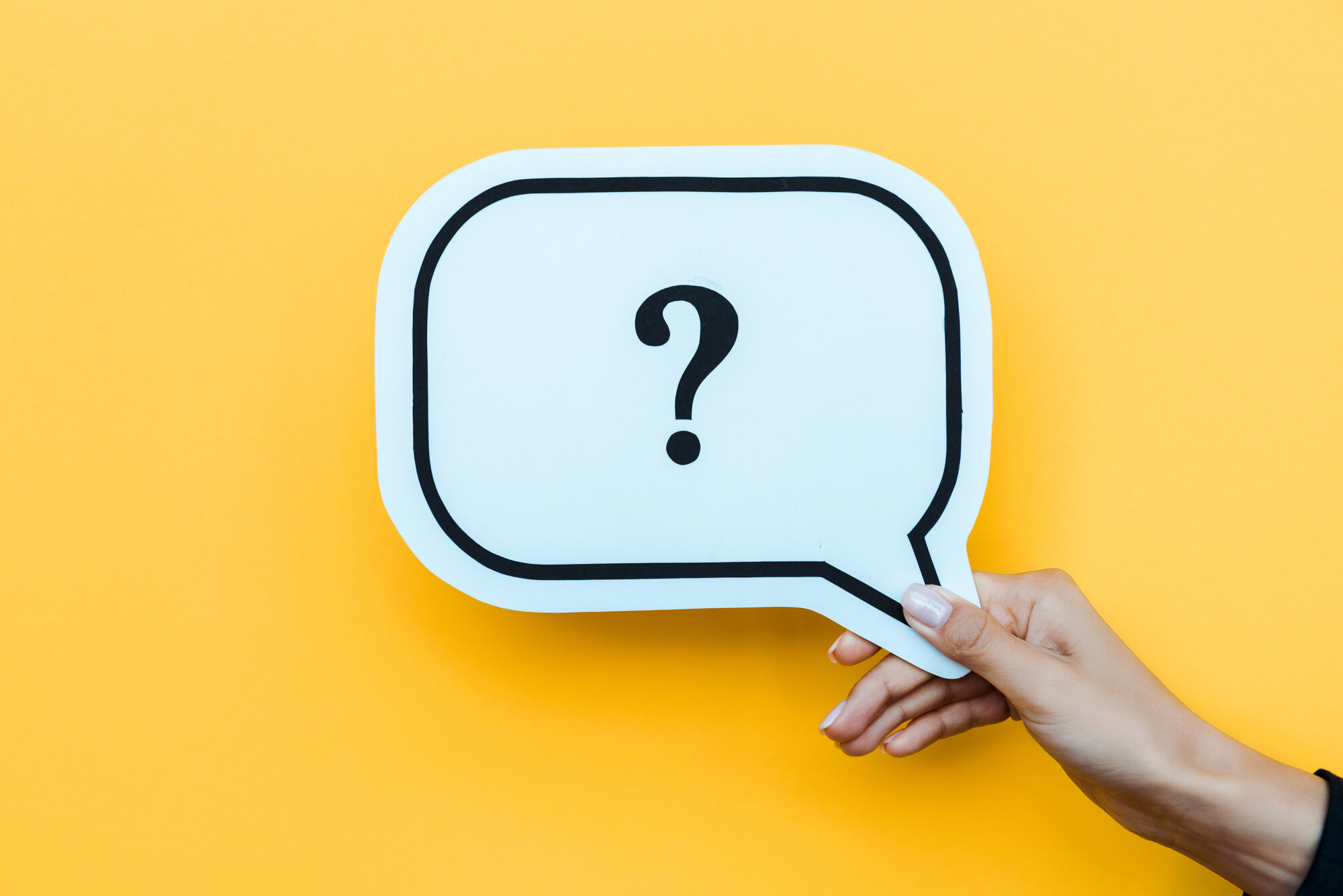 hand holding speech bubble with question mark