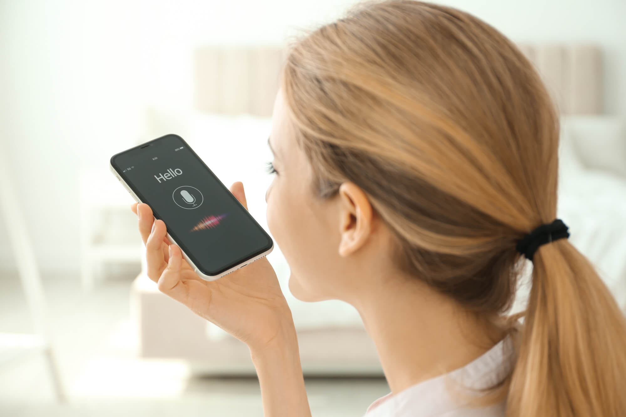 woman speaking to her phone happily