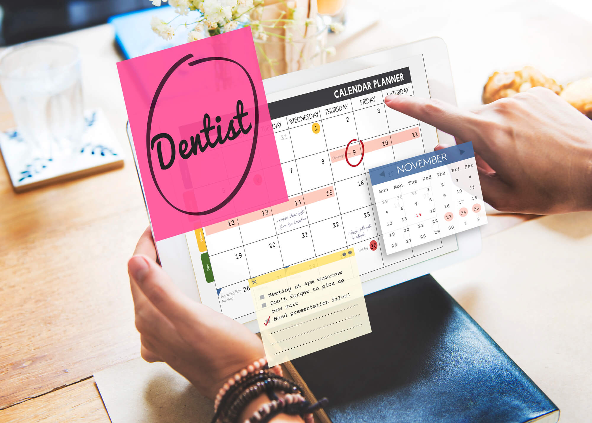 person using tablet to schedule dental appointment