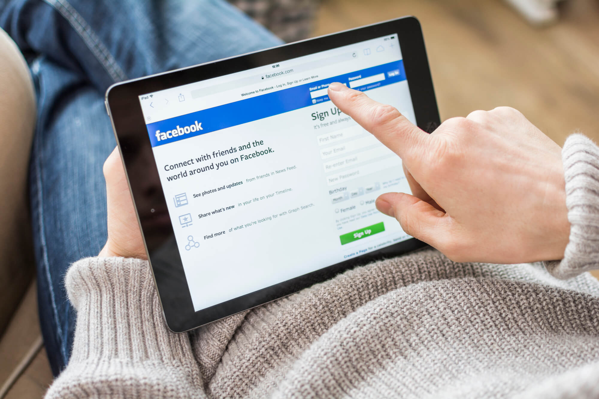 woman using facebook on ipad