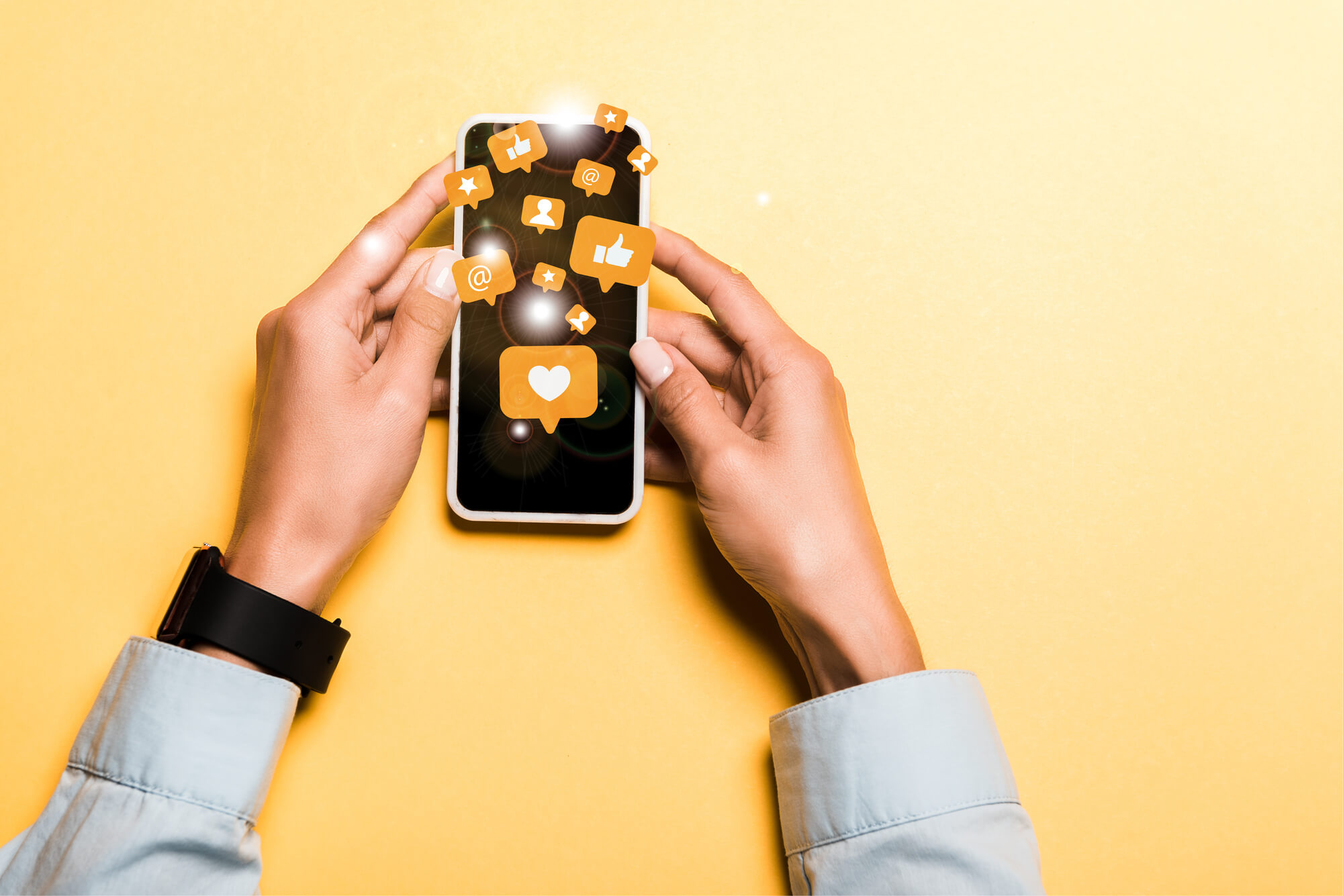 woman holding phone with speech bubbles containing social media actions