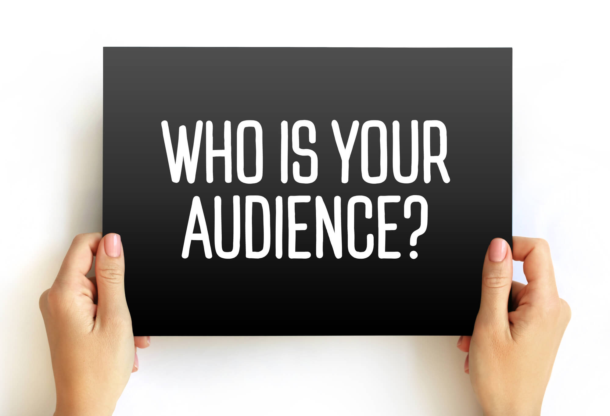 hands holding sign asking "who is your audience?"