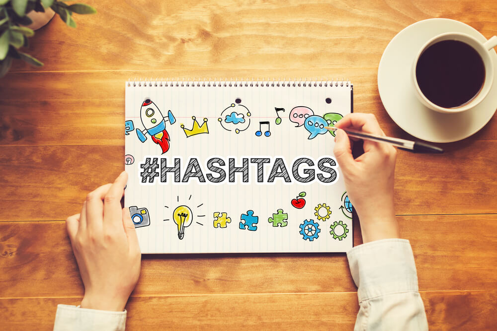 the word hashtag sketched on a notepad. 