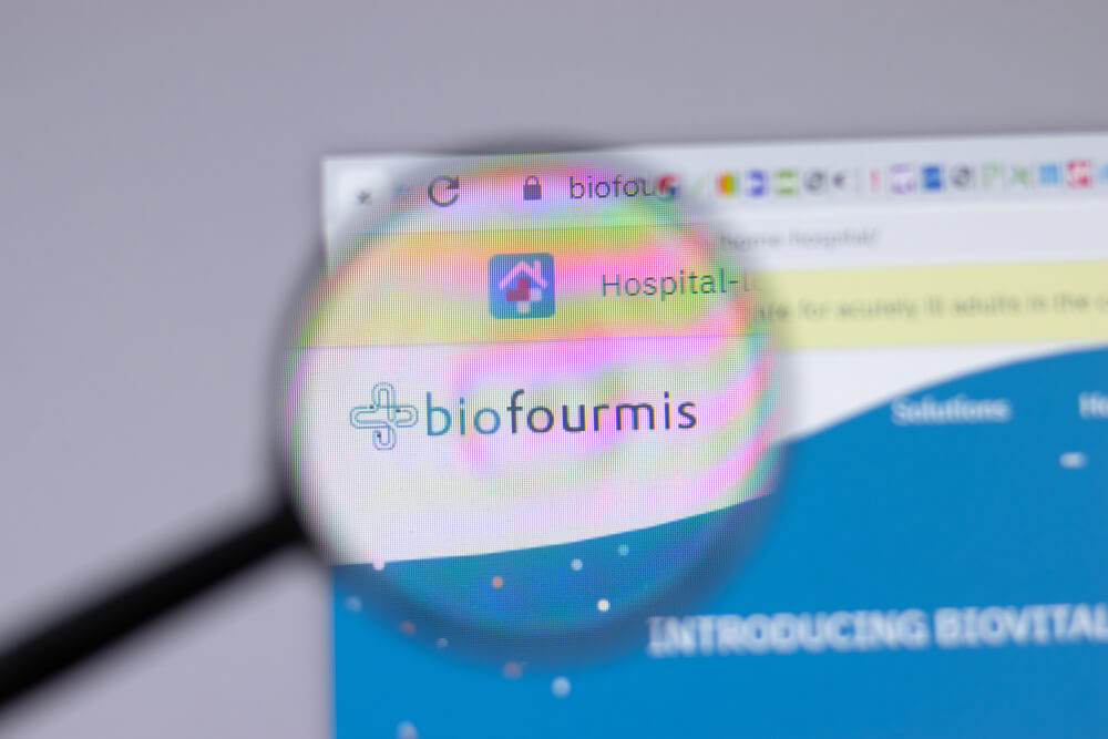 a small logo of a company under a magnifying glass to improve its readability 