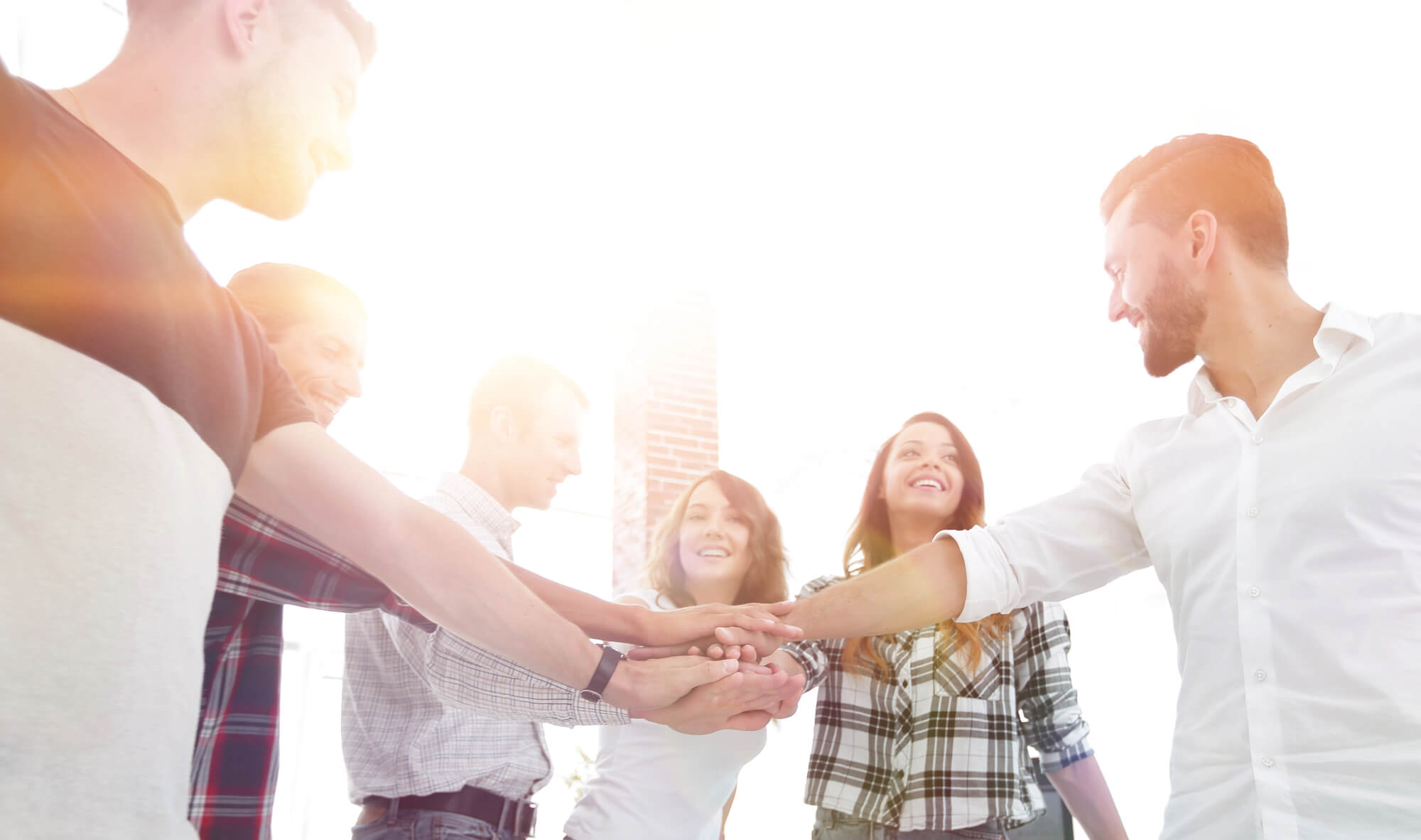 entrepreneurs clasping their hands together