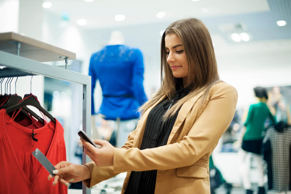 Customer scanning QR code to download retail store app. 