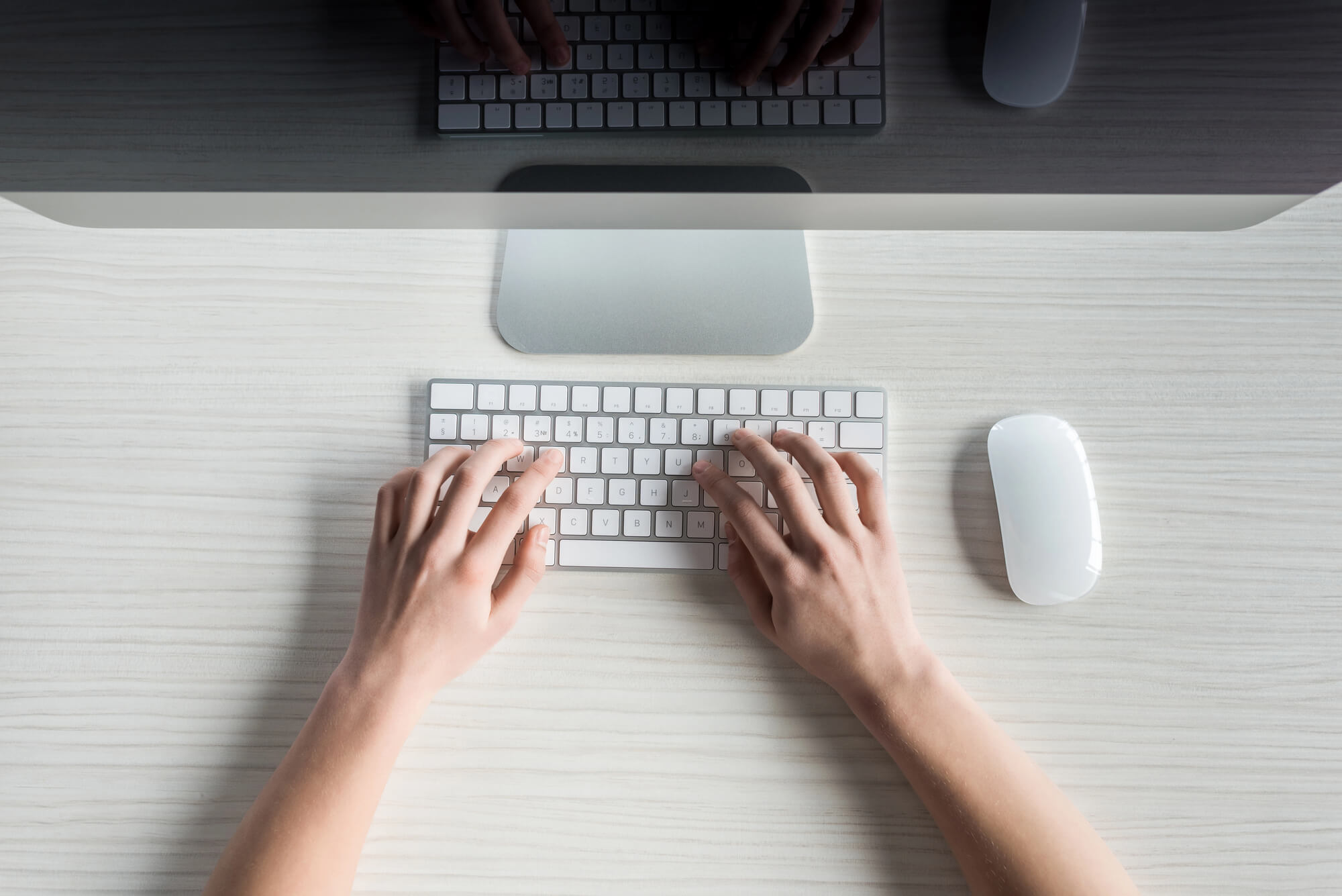 hands typing on keyboard