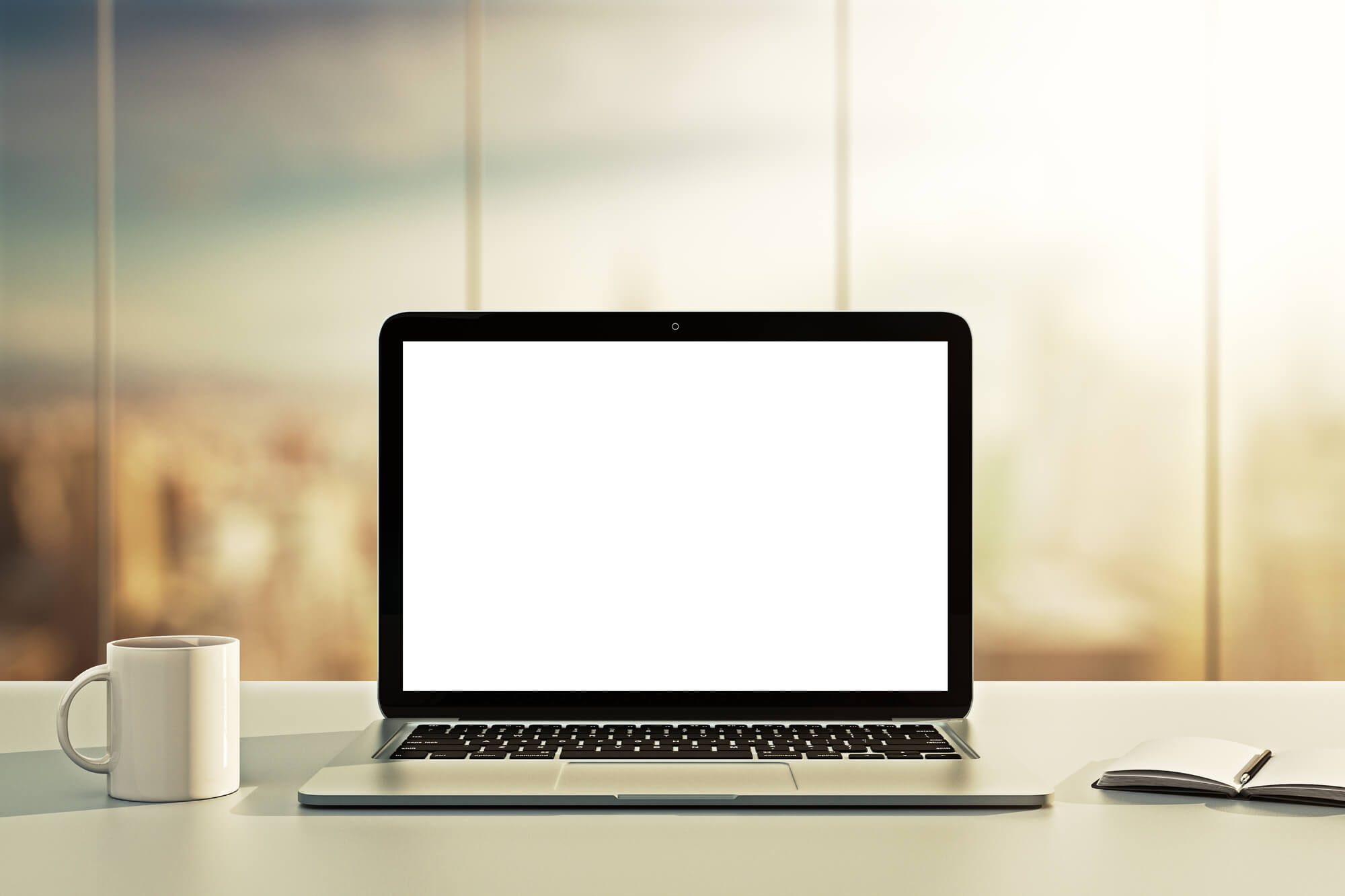 laptop with mug and notebook