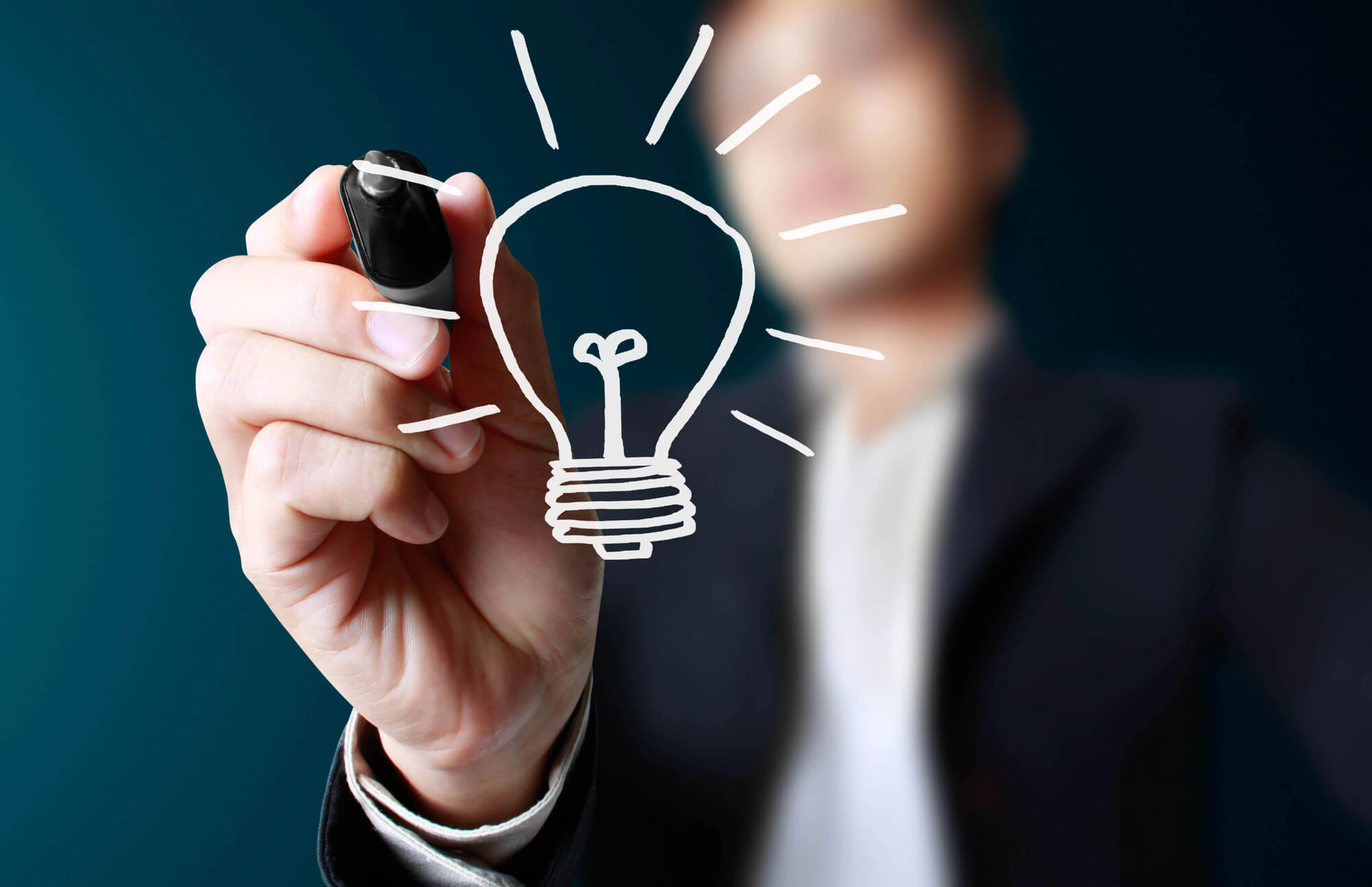 businessman drawing a light bulb