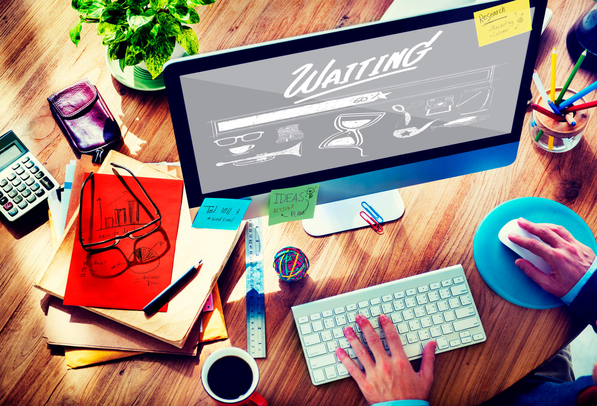 businessman using laptop with a loading bar that says waiting on screen