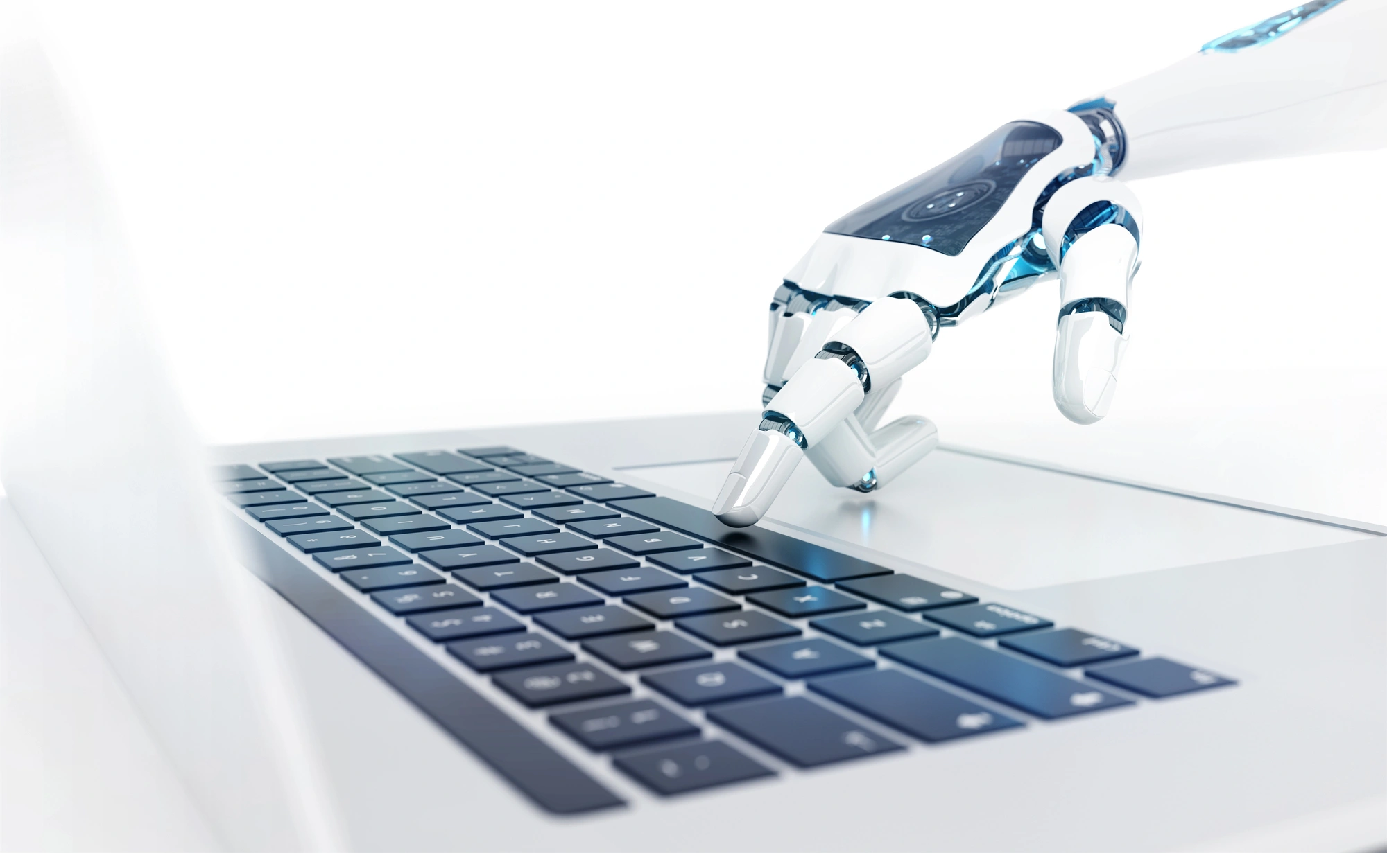 A robotic hand hovers over a laptop keyboard, poised to type. The sleek design suggests modern technology, conveying innovation and artificial intelligence