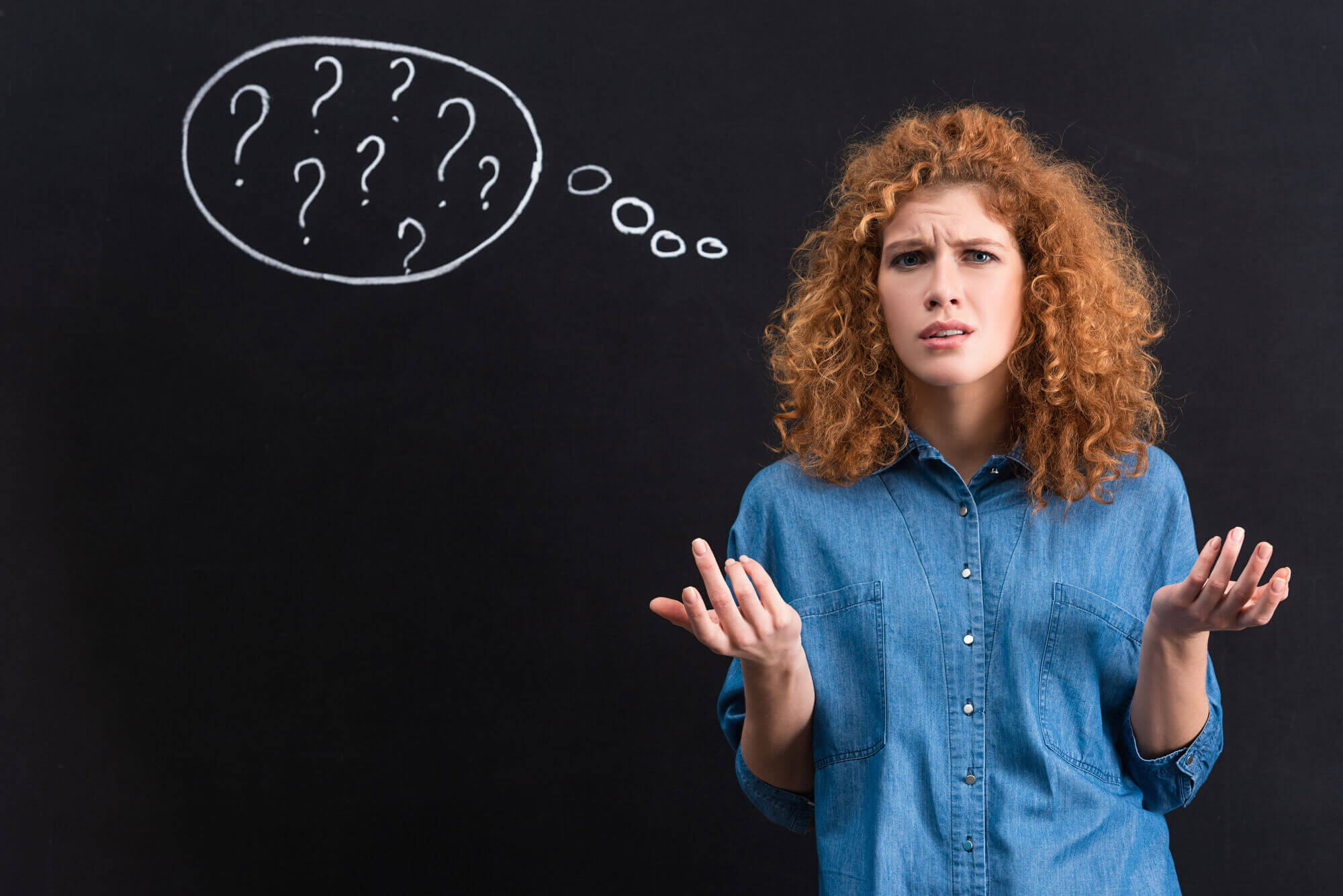 young woman shrugging with question marks in thought bubble on background