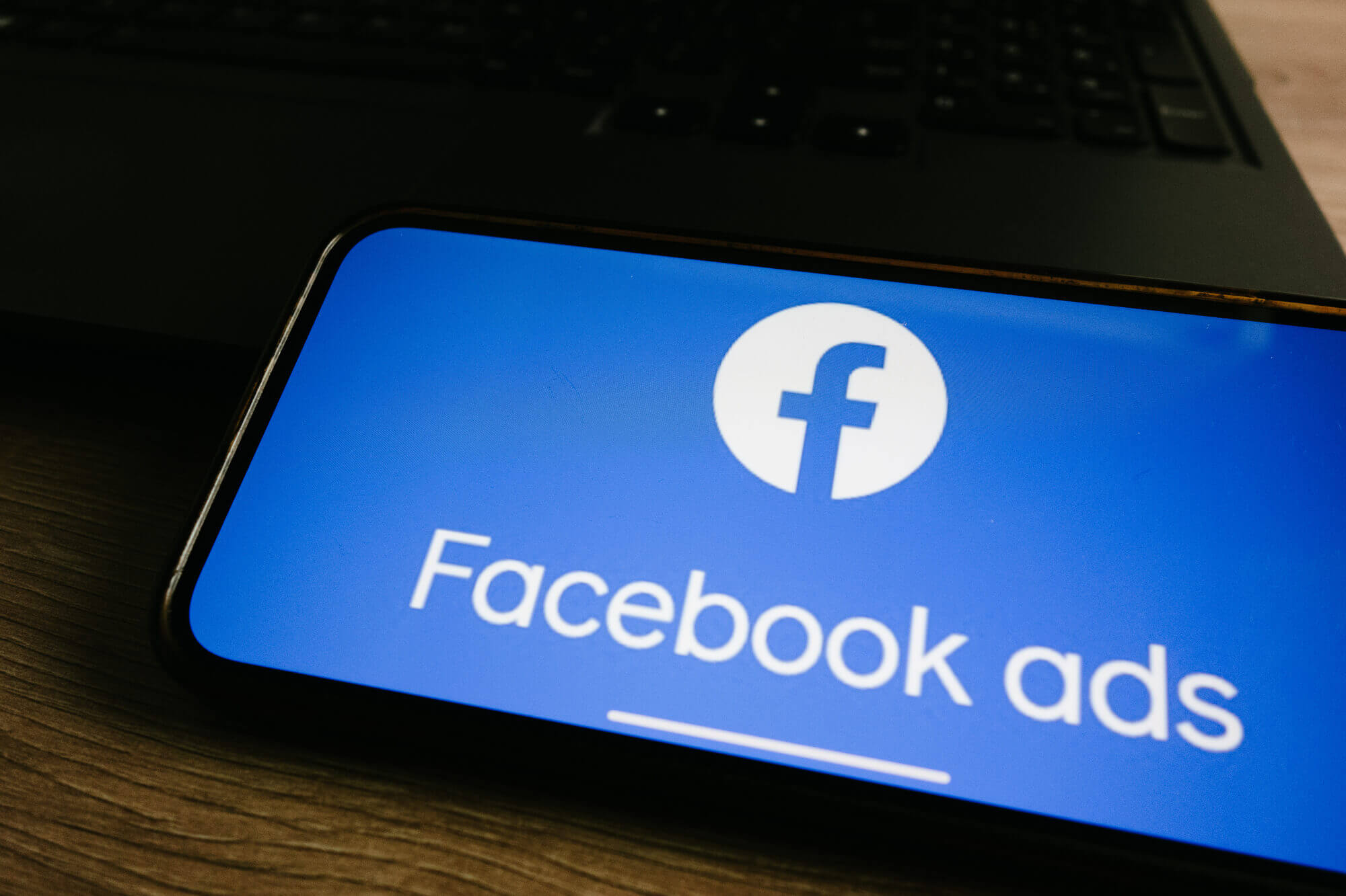 smartphone showing Facebook ads on screen