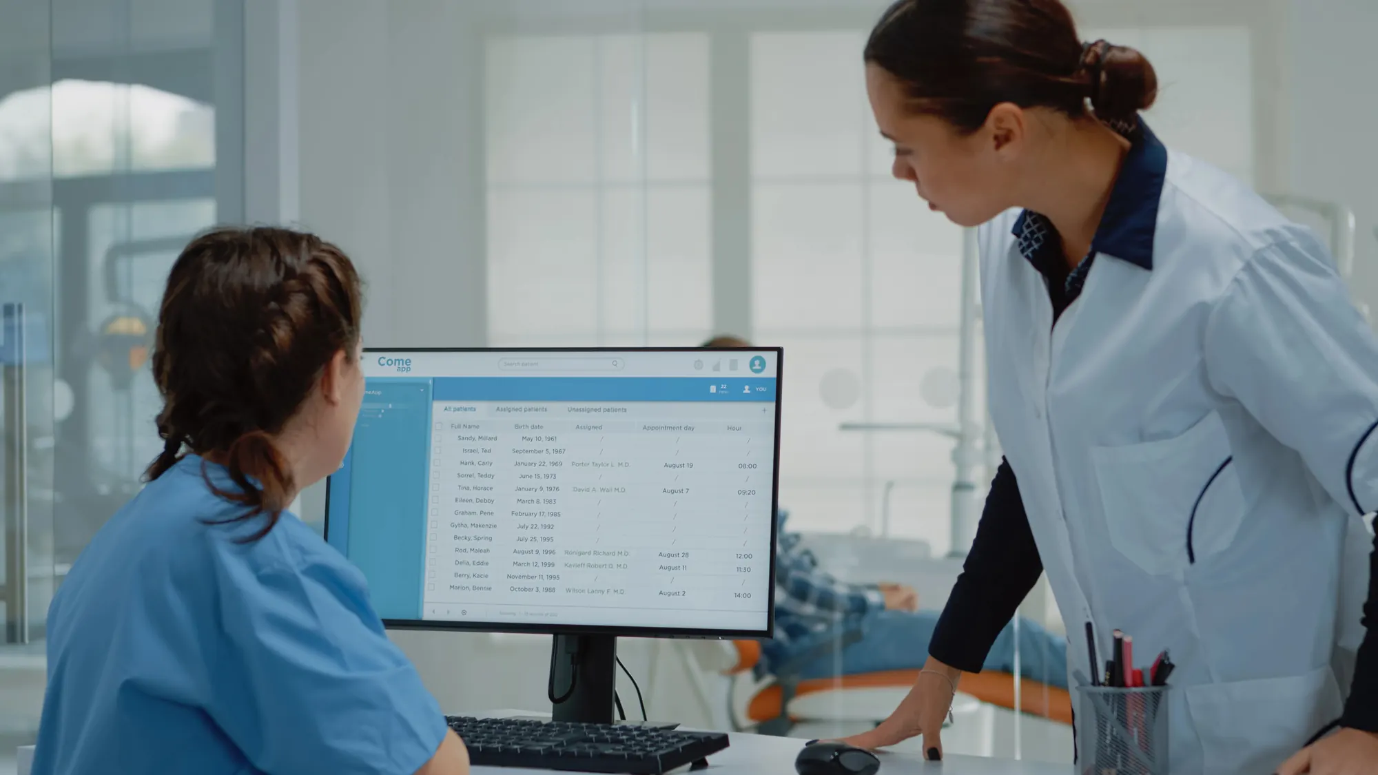 Dental team reviewing patient management software and appointment data on a computer screen as part of dental marketing and practice operations
