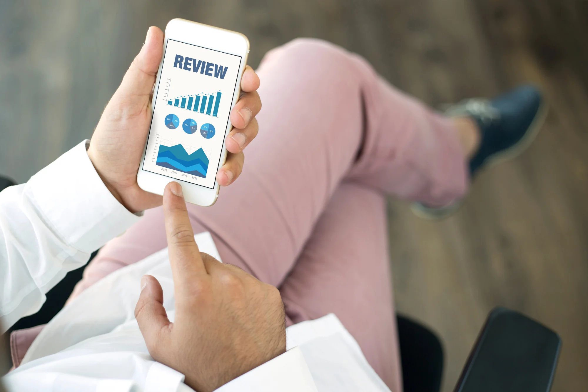 Business professional reviewing a customer review analytics dashboard on a smartphone for Google review management