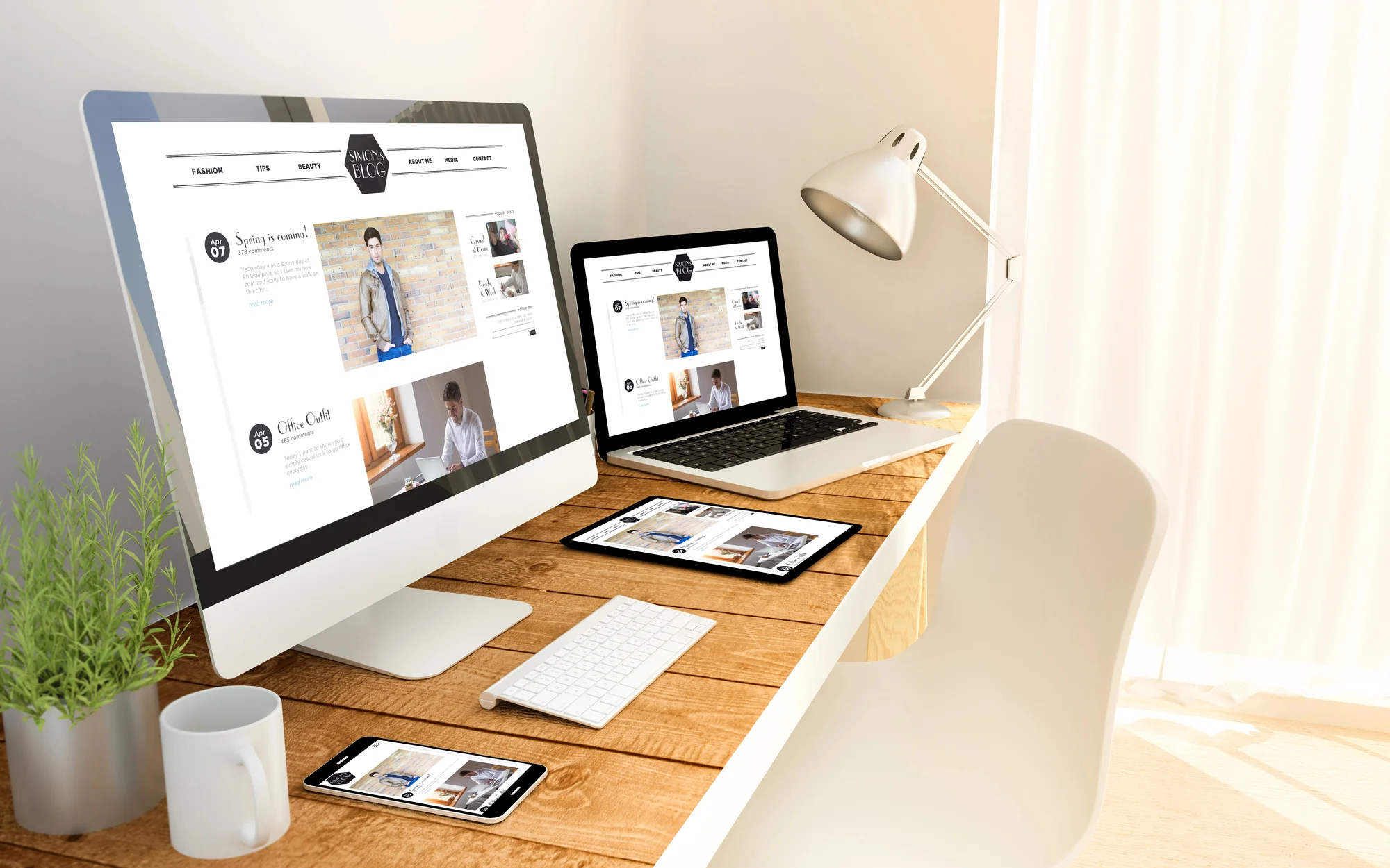 Blog website displayed across a desktop monitor, laptop, tablet, and smartphone on a wooden desk, showing a responsive lead generation website design