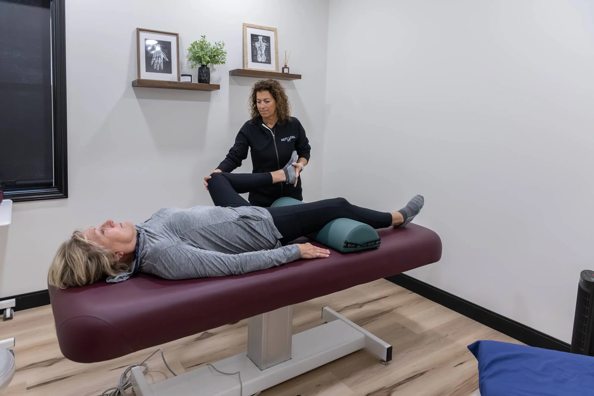 Dr. Gina Croft applying hip joint mobilization at Next Level PT physical therapy Westlake.
