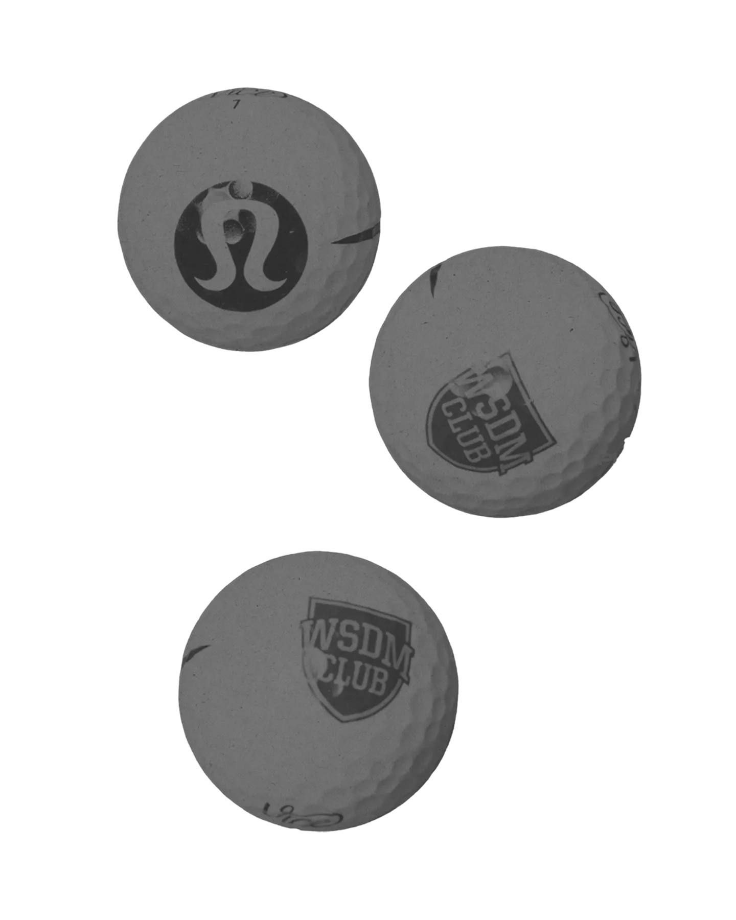 Three golf balls with logos, including Lululemon and WSDM CLUB, on a white background.
