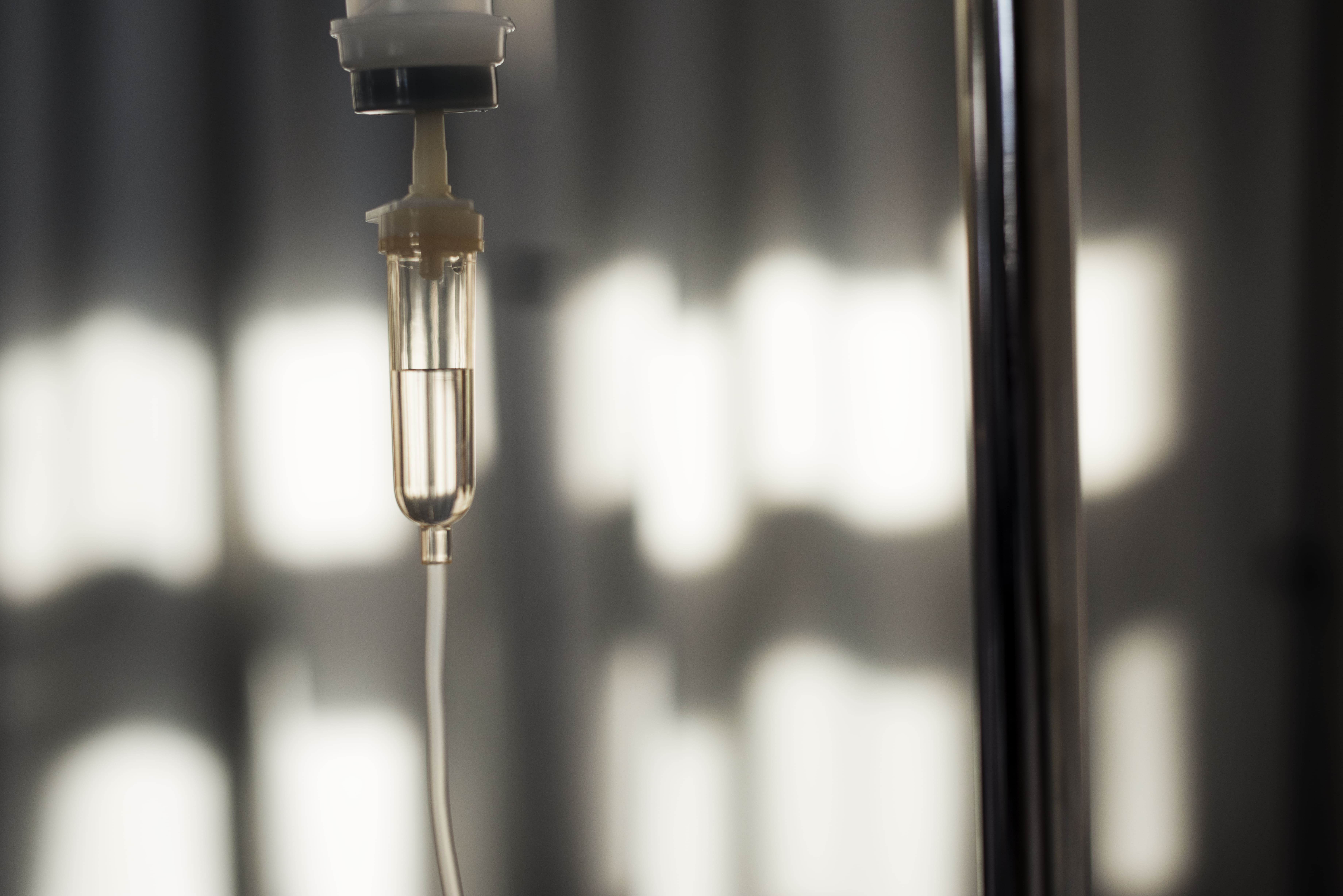 Close-up of an IV drip chamber during hydration therapy at Aevum Houston