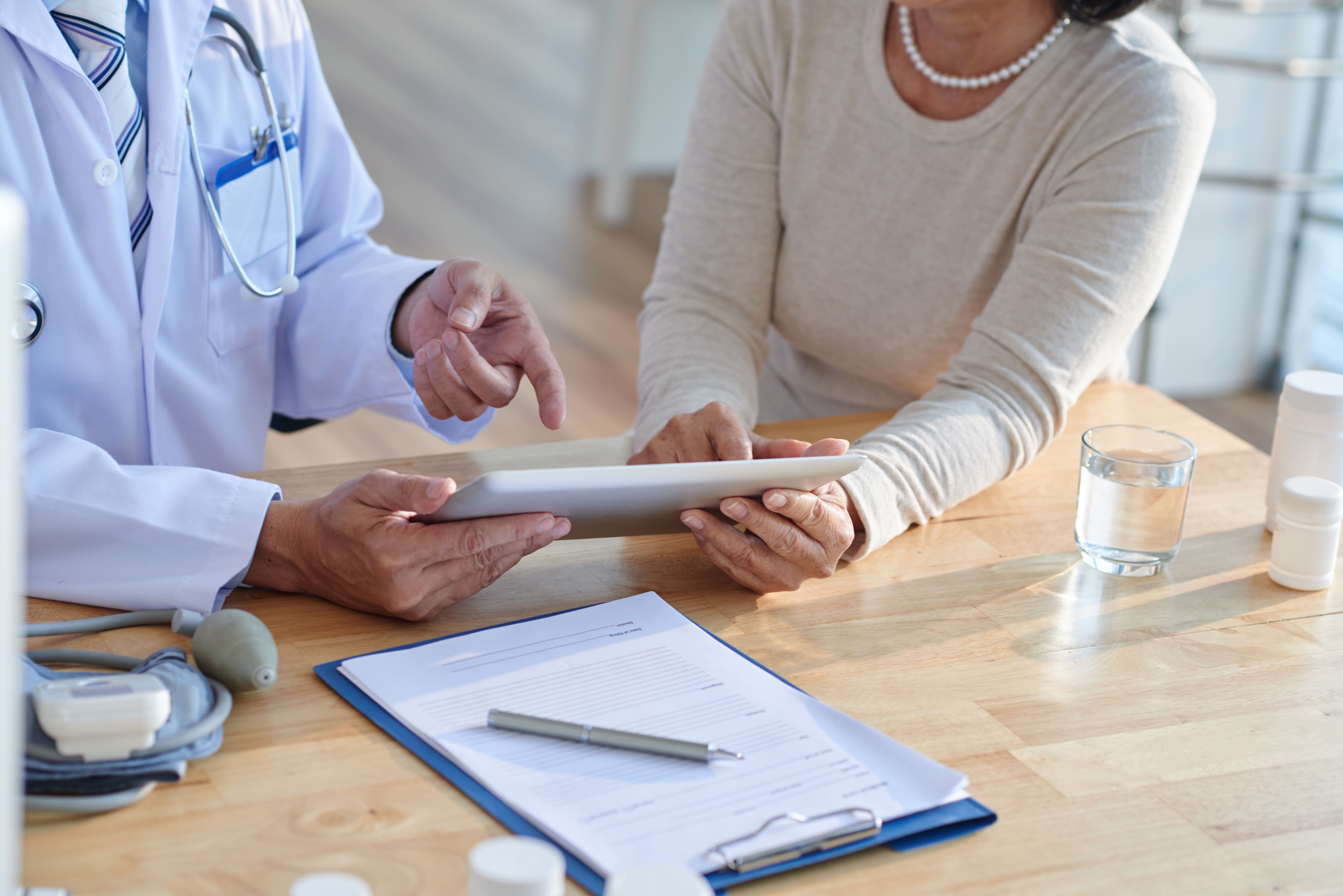 Physician reviewing laboratory results with a patient at Aevum in Houston