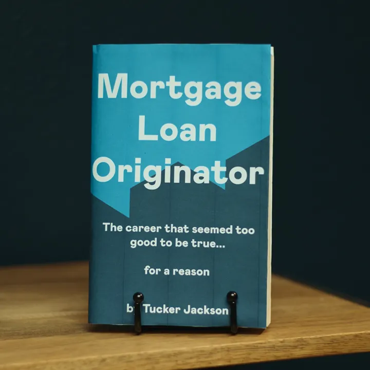 Mortgage Loan Originator book on a wooden table.