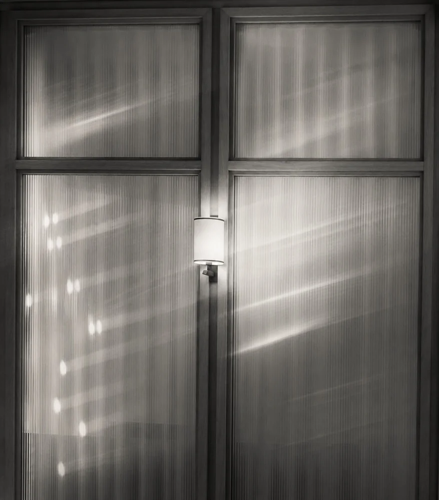 Black and white detail of light falling across a window