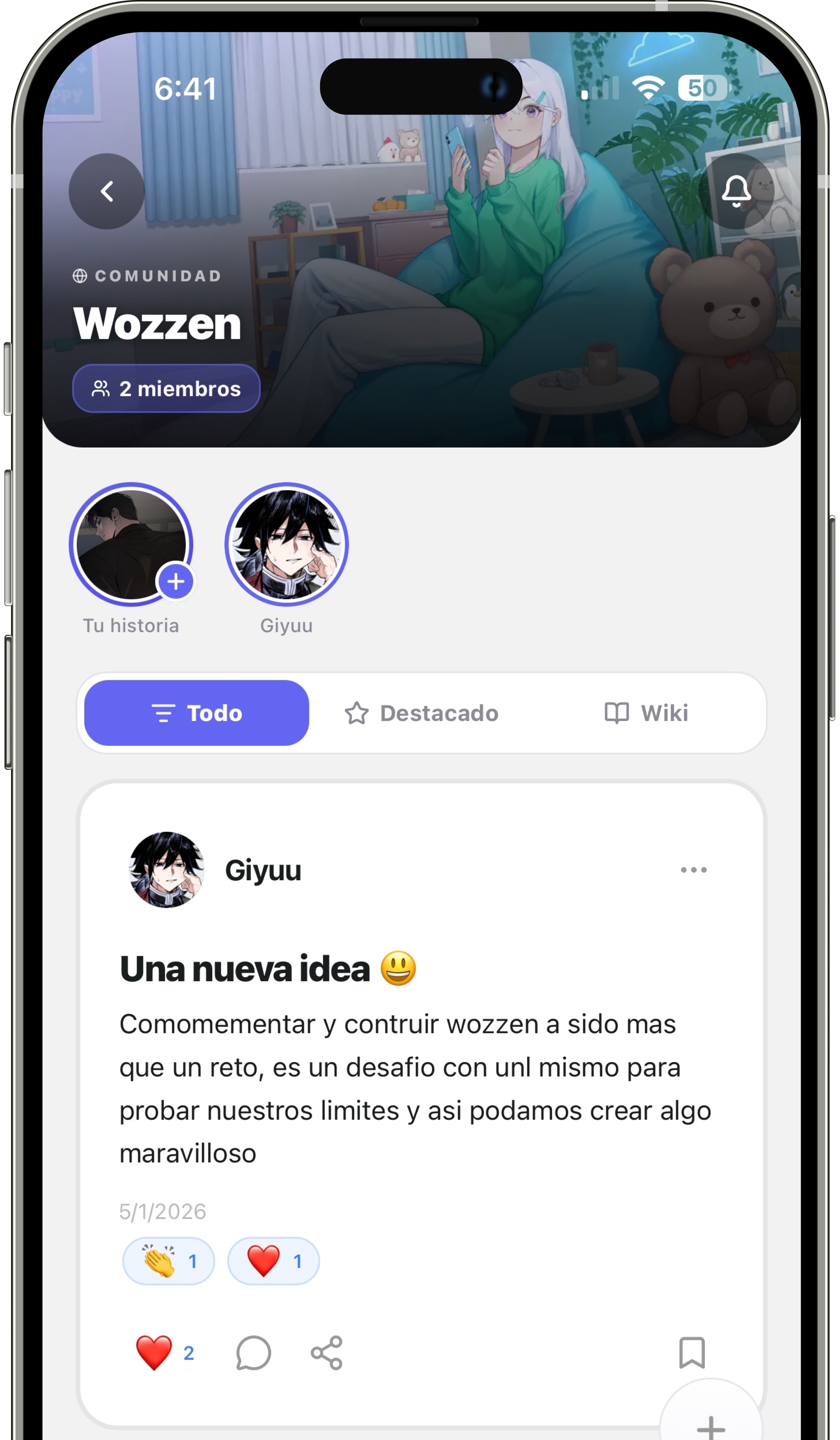 Mobile app screen showing Wozzen community with two members, a post by Giyuu titled 'Una nueva idea' discussing building Wozzen as a challenge with emojis for reactions.
