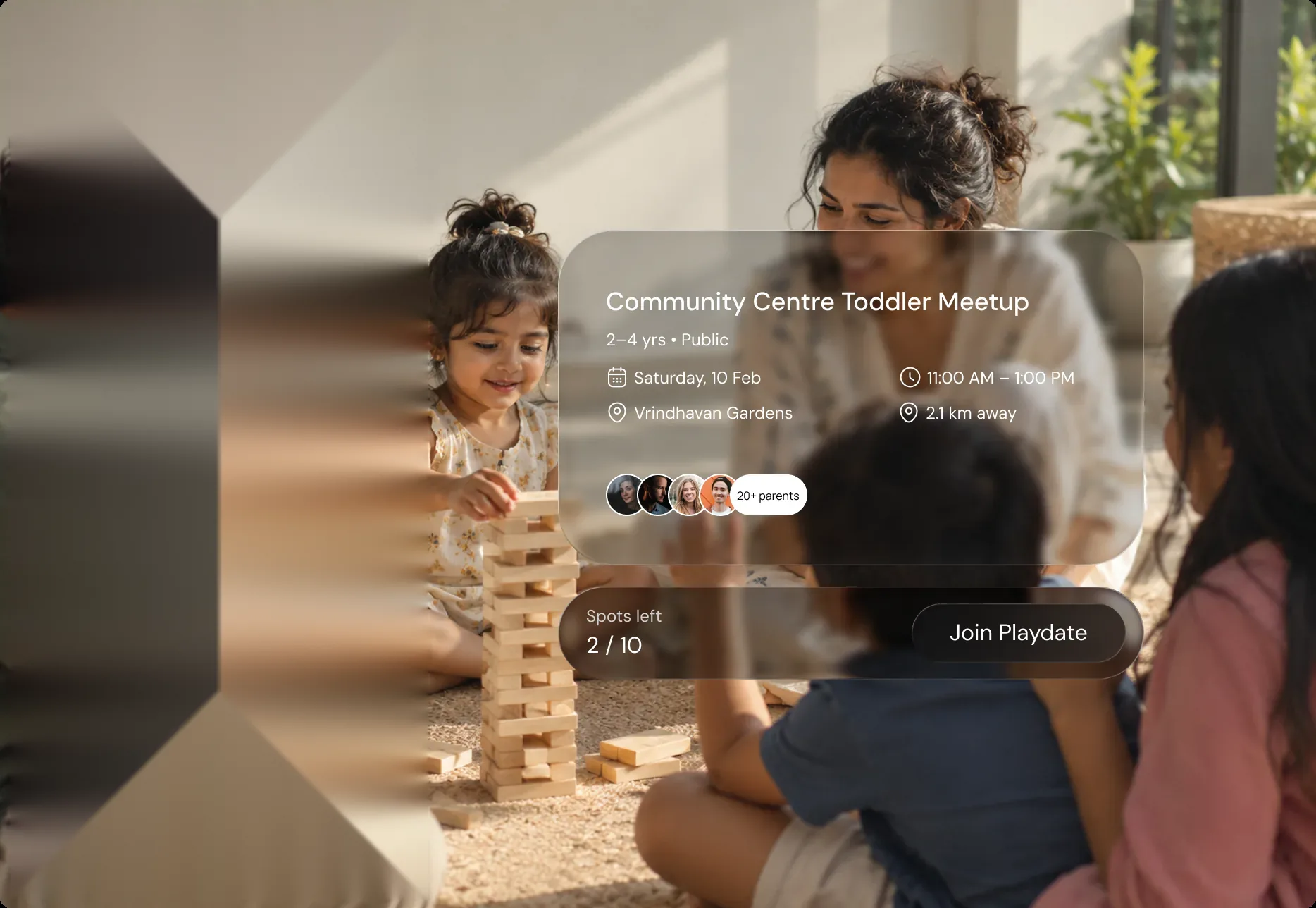 Parents and toddlers playing together with a toddler meetup event card