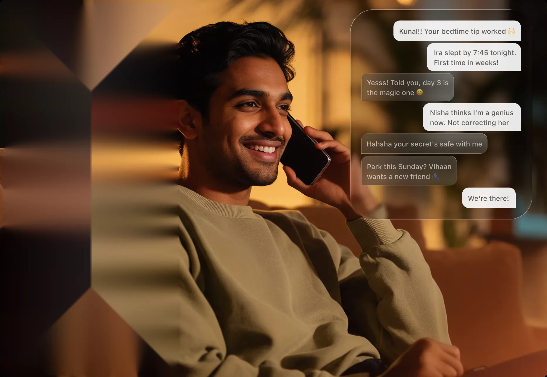 A father smiling on a phone call beside chat messages from other parents