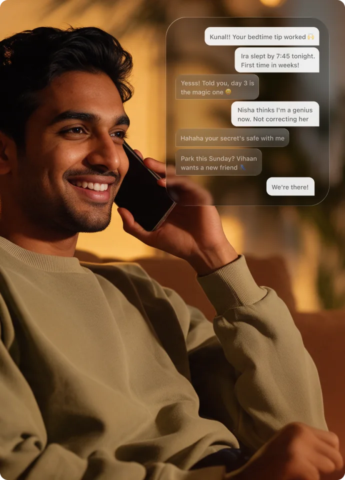 A father smiling on a phone call beside chat messages from other parents