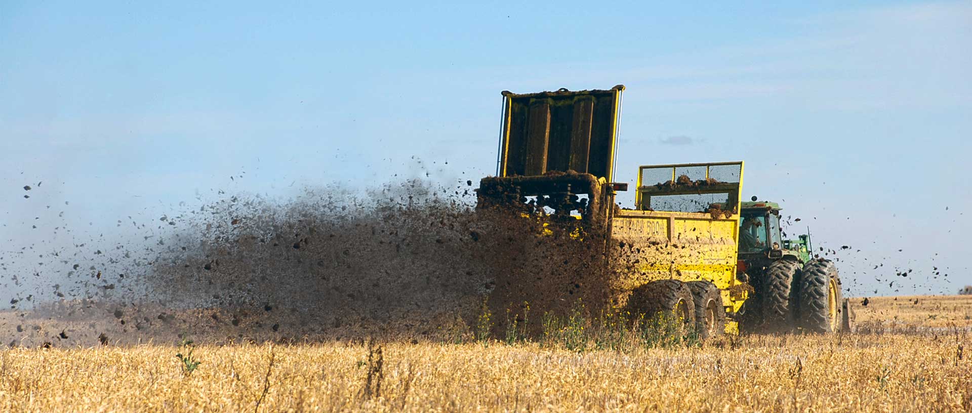 Manure spreader applying recovered organic nutrients to farmland