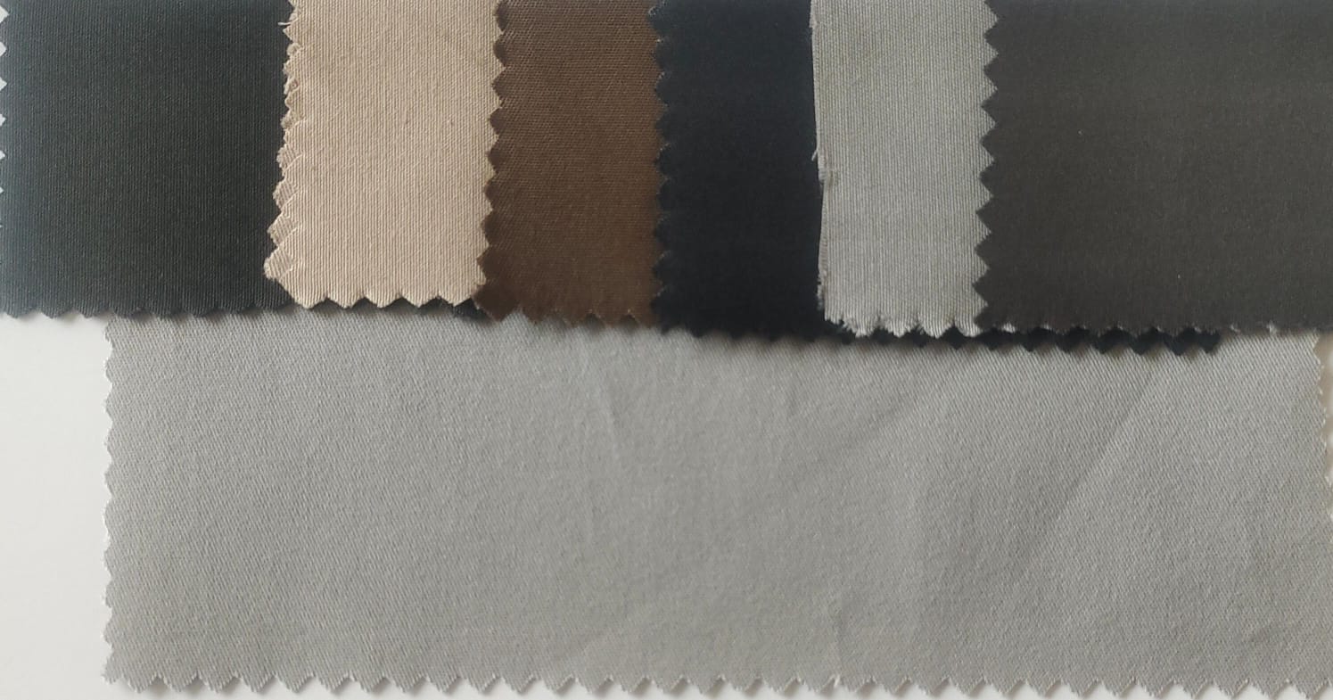 Close-up of soft, wrinkled pink cotton fabric displaying fine weave texture.