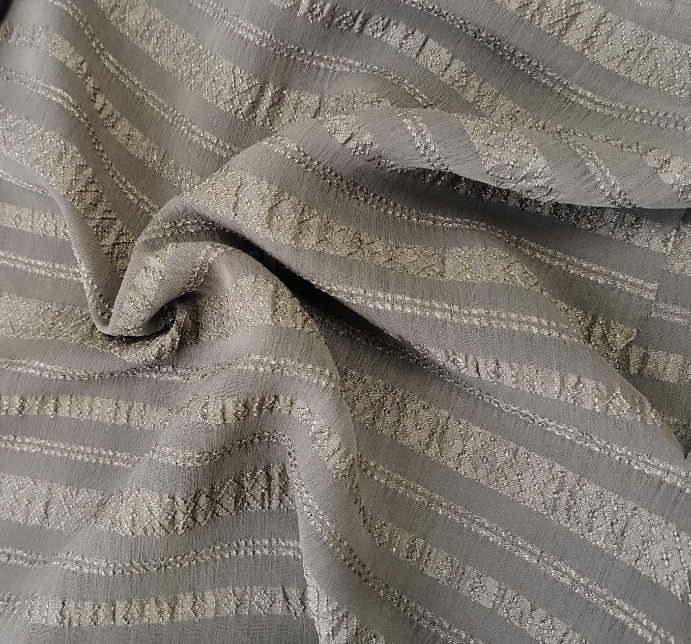 Close-up of soft, wrinkled pink cotton fabric displaying fine weave texture.