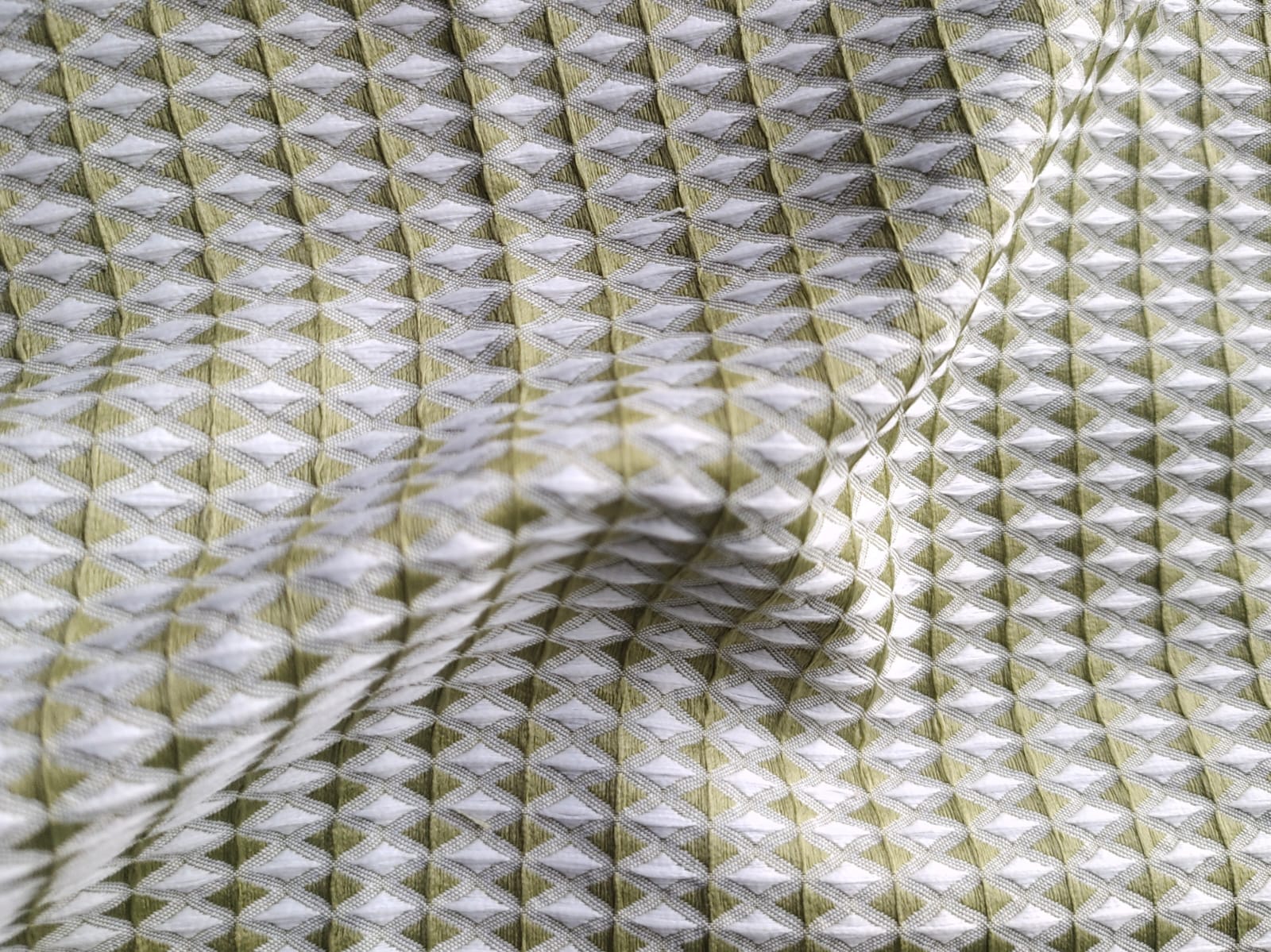 Close-up of soft, wrinkled pink cotton fabric displaying fine weave texture.
