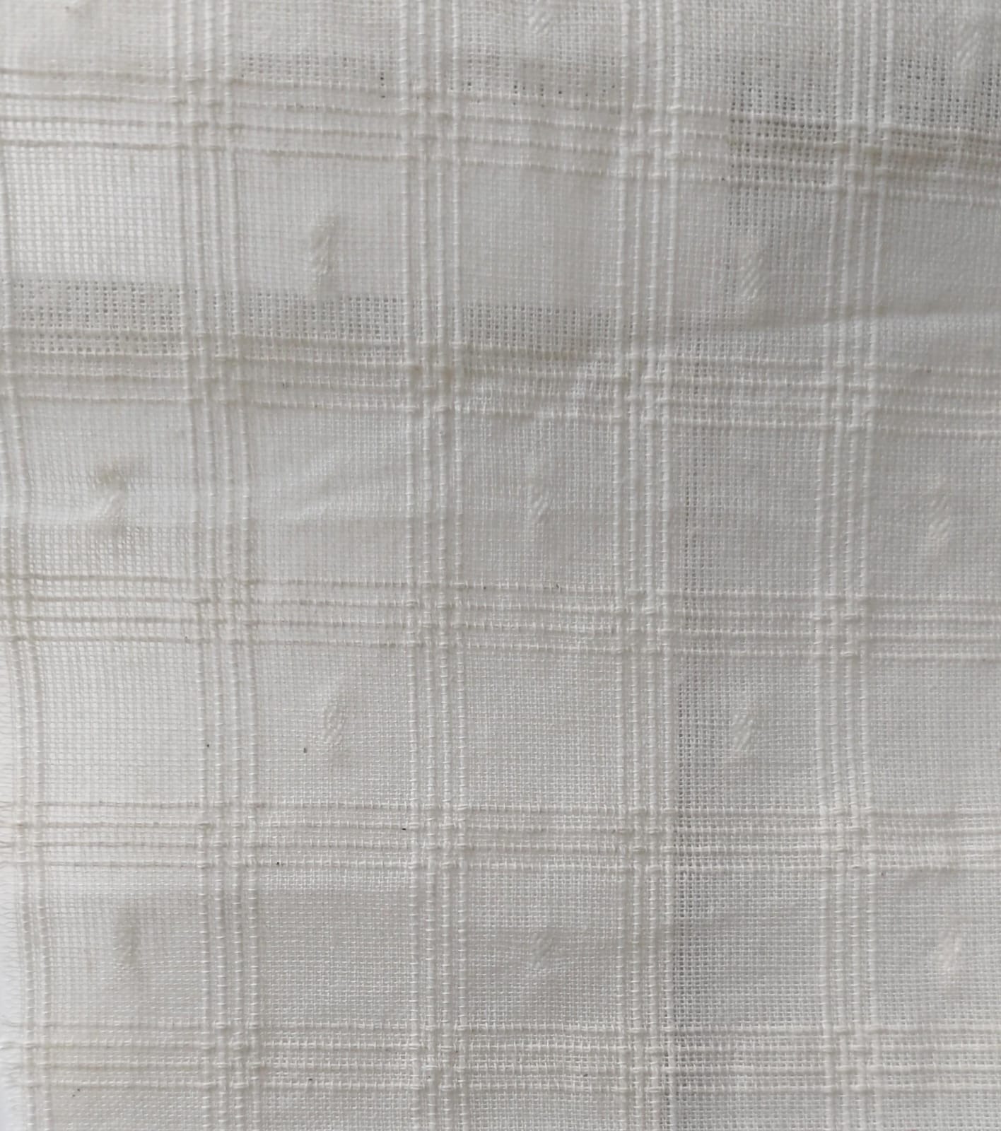 Close-up of soft, wrinkled pink cotton fabric displaying fine weave texture.