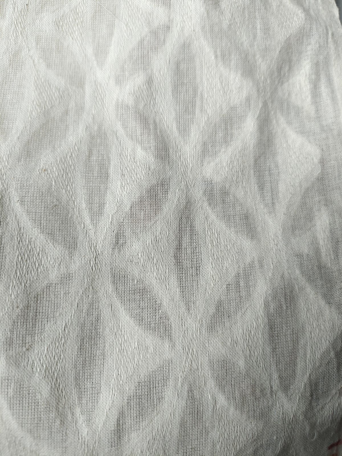 Close-up of soft, wrinkled pink cotton fabric displaying fine weave texture.