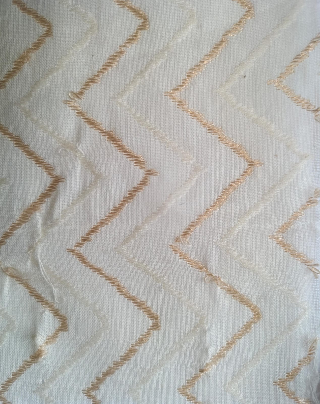 Close-up of soft, wrinkled pink cotton fabric displaying fine weave texture.