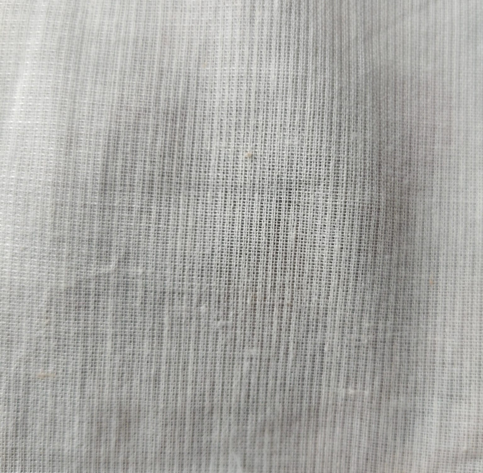 Close-up of soft, wrinkled pink cotton fabric displaying fine weave texture.
