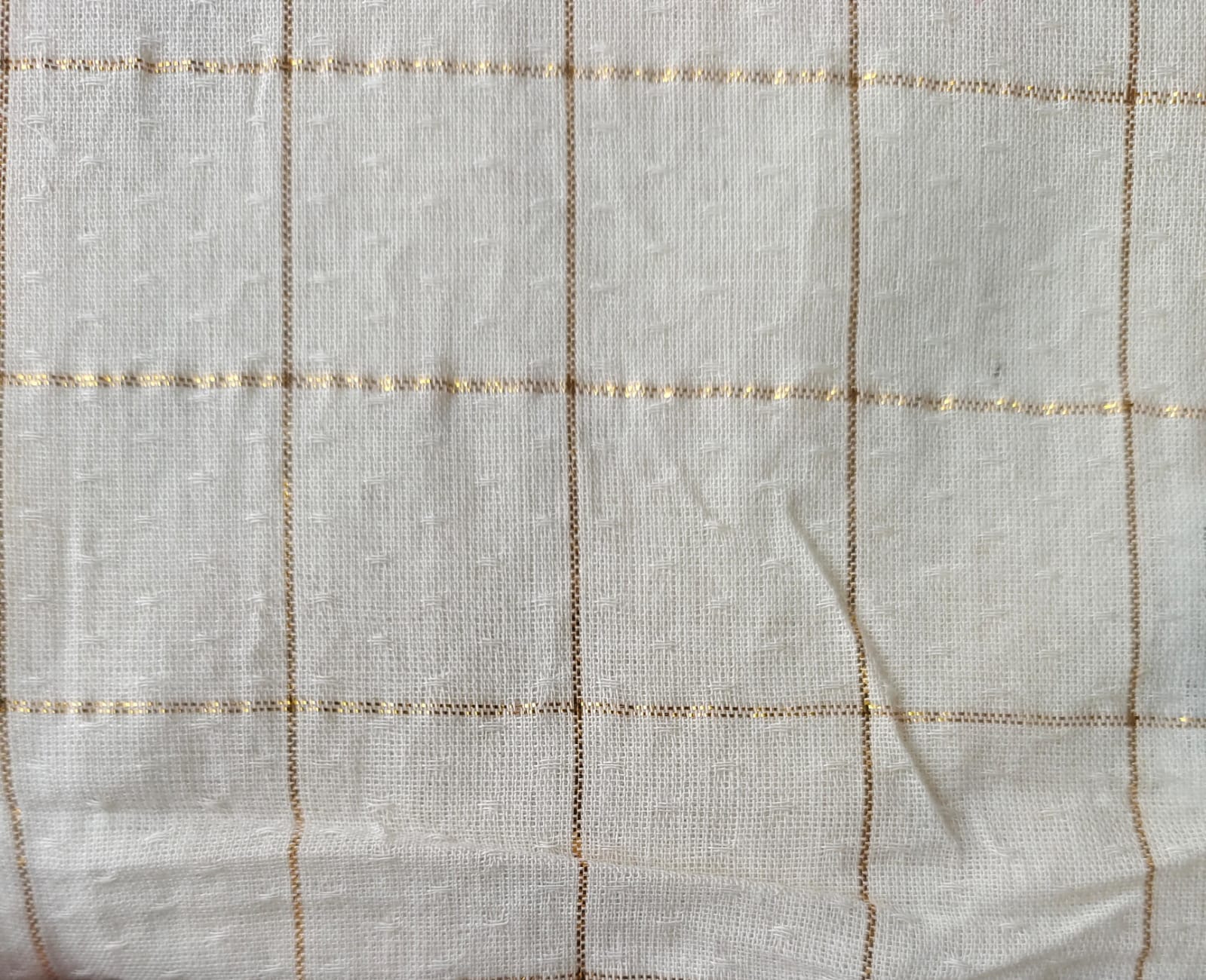 Close-up of soft, wrinkled pink cotton fabric displaying fine weave texture.
