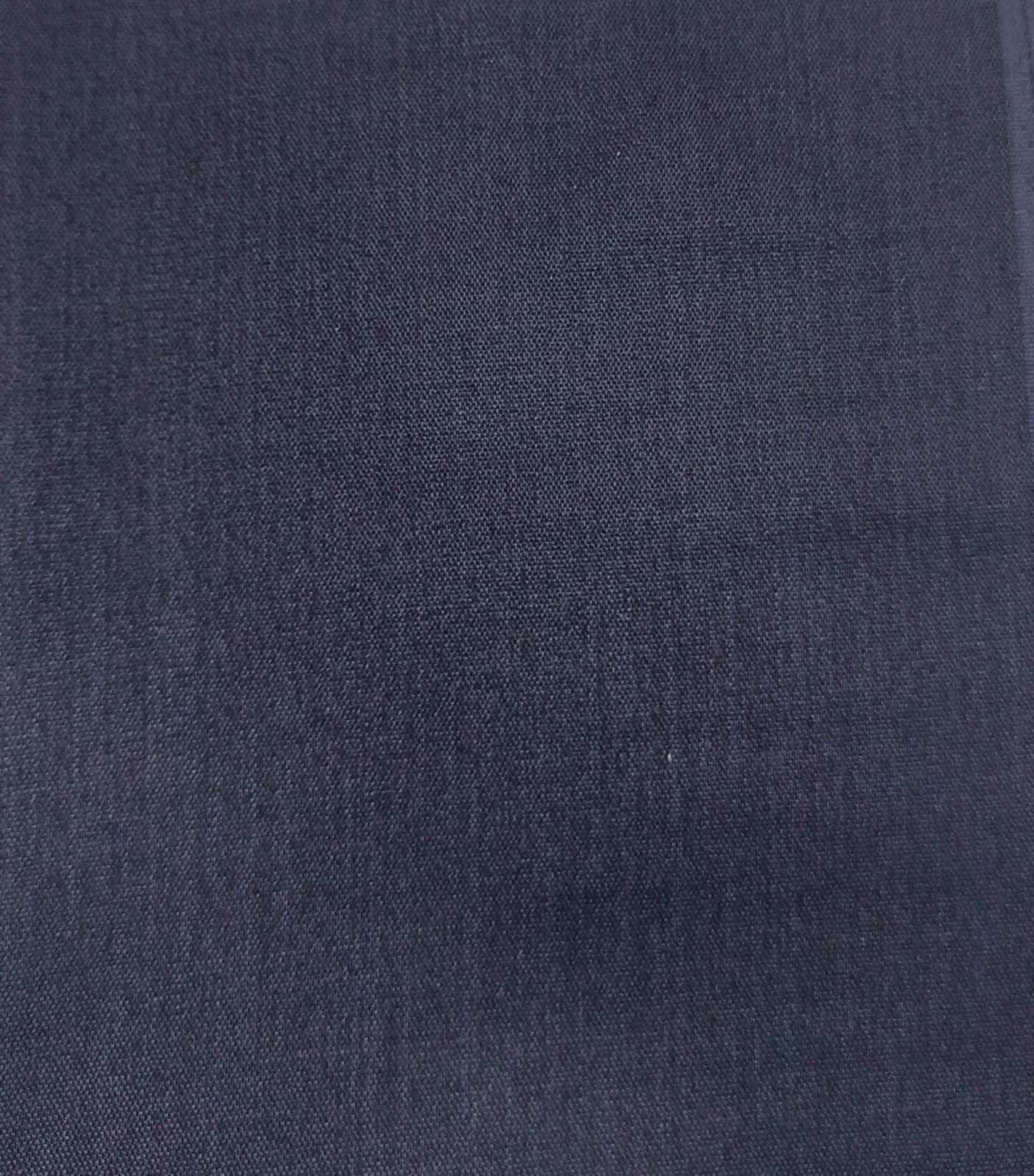Close-up of soft, wrinkled pink cotton fabric displaying fine weave texture.