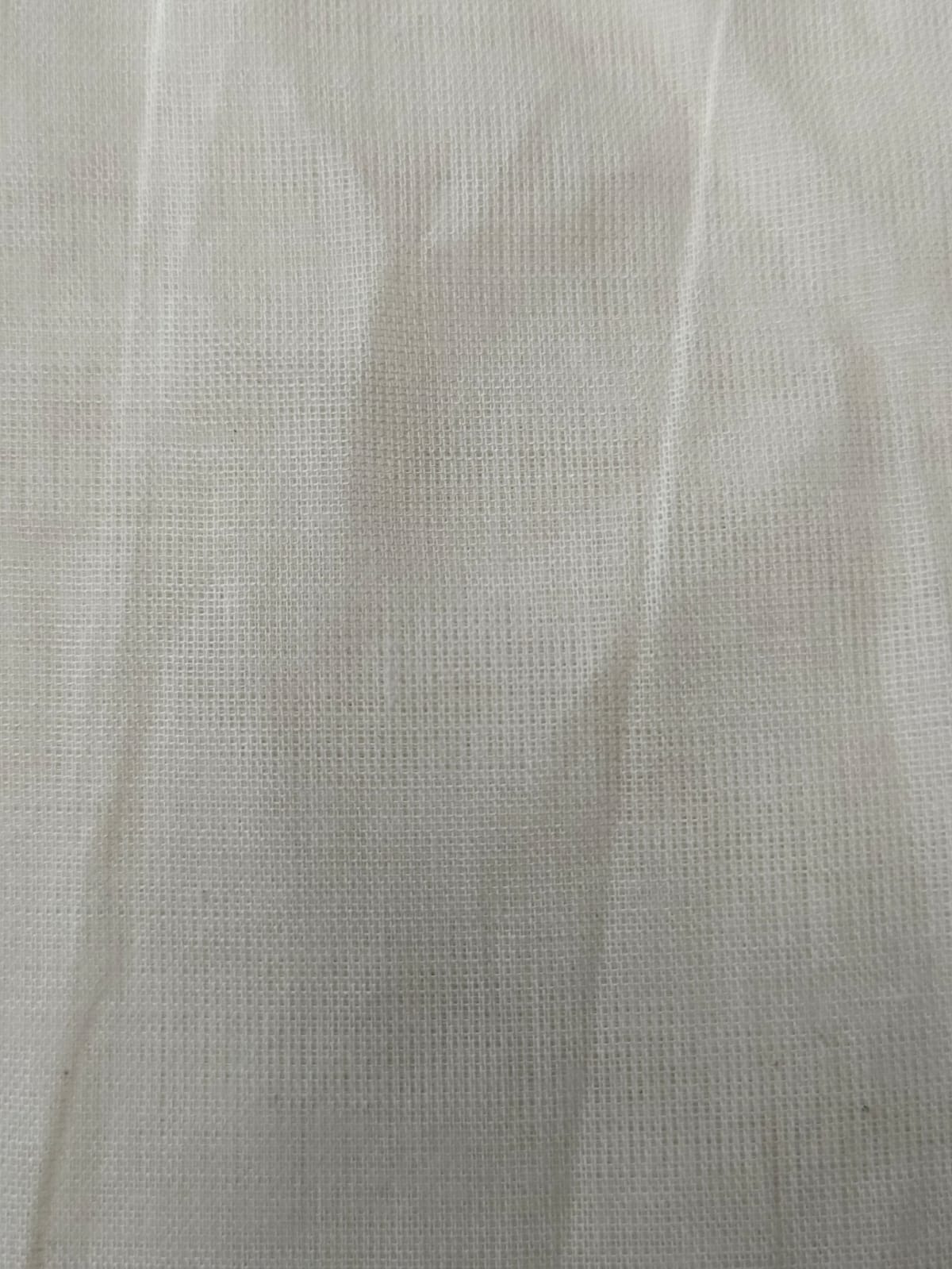 Close-up of soft, wrinkled pink cotton fabric displaying fine weave texture.