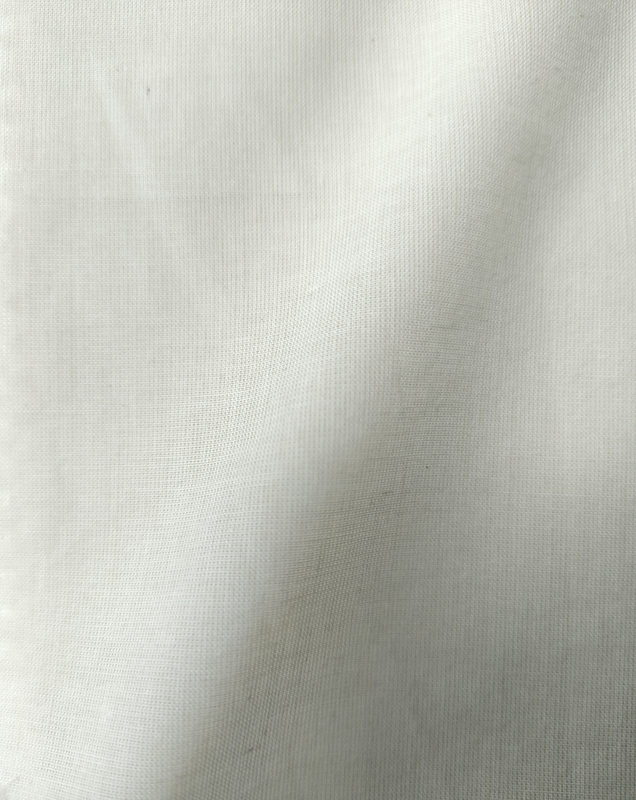 Close-up of soft, wrinkled pink cotton fabric displaying fine weave texture.
